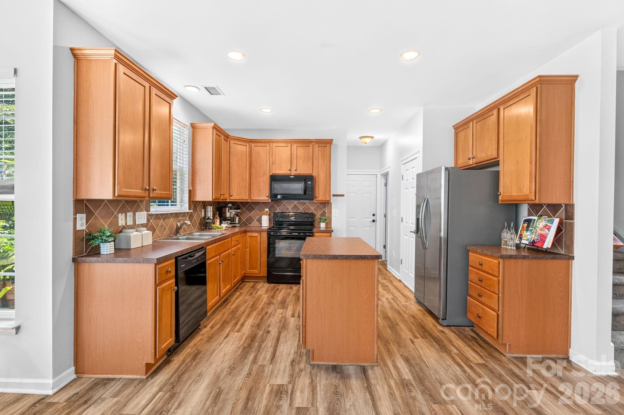 Kitchen. Functional kitchen with black appliances, pantry, and plenty of workspace. - Charlotte