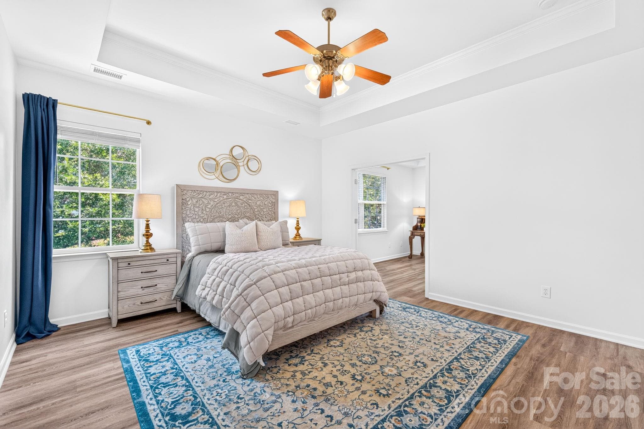 Primary BedroomSpacious primary suite with tray ceiling and room for a sitting area. - Charlotte