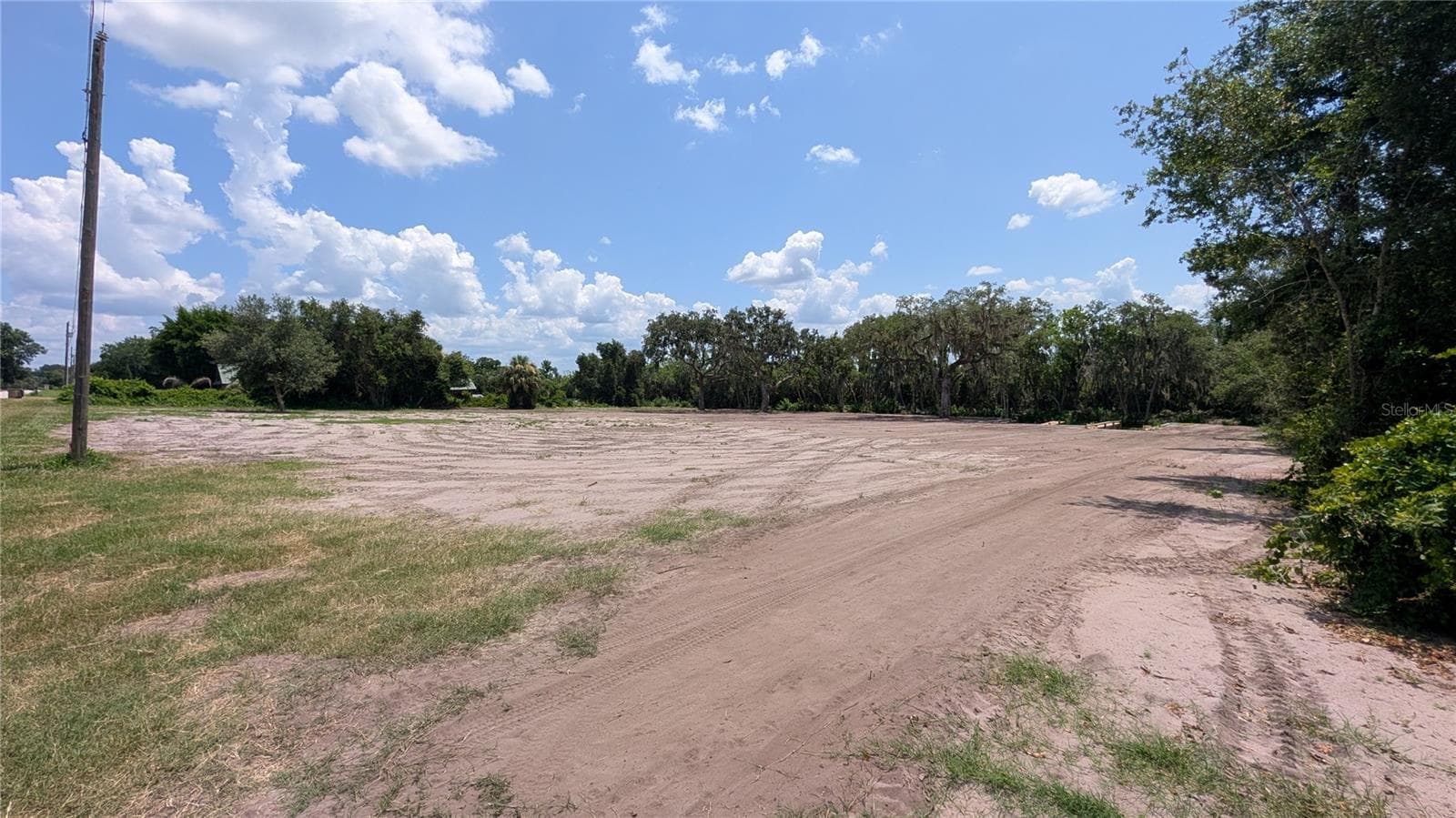Cleared property viewed from back corner near road; canal is on the far end - SULEN RD, LADY LAKE
