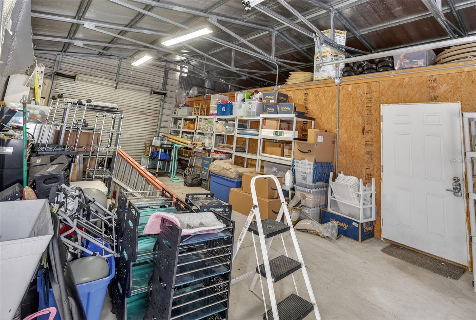 Inside the workshop you'll find the pass through garage with entry and exit garage door, separate aire conditioned space and utility tub/sink. - 1210 408TH CT E, MYAKKA CITY