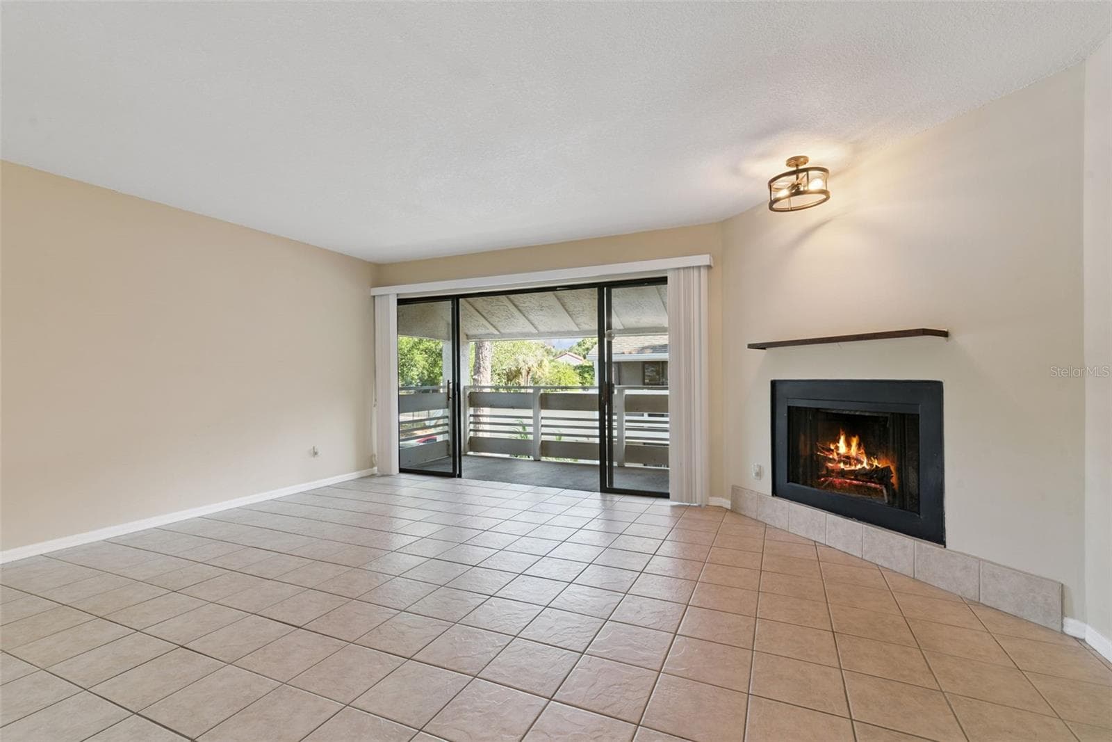 Wood burning fireplace and access to balcony from the living room - 445 S NETHERWOOD CRES #2, ALTAMONTE SPRINGS