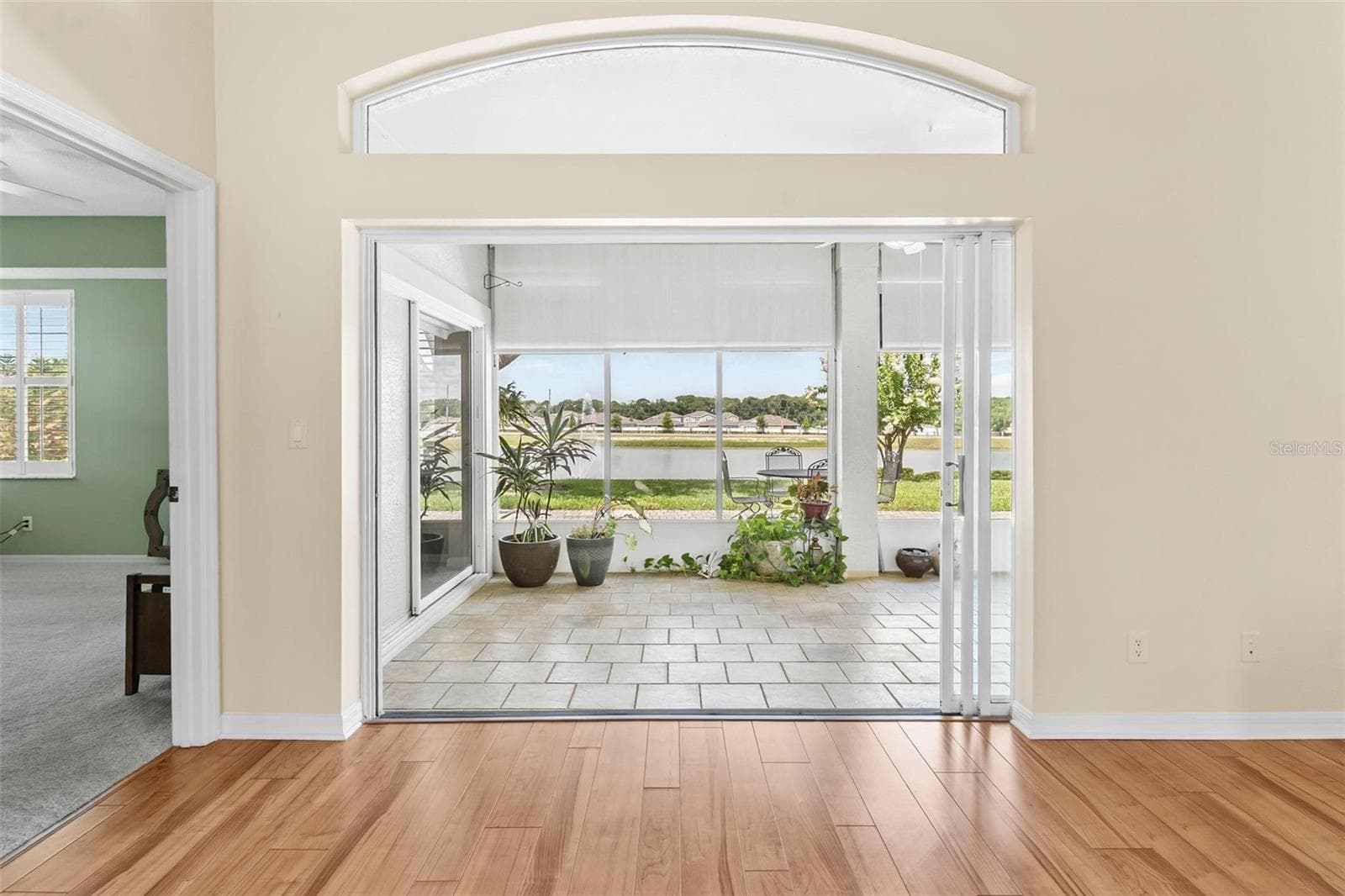 View of Lake Laemont Through Living Room and Florida Room. - 3354 SAINT LUCIA CT, TAVARES