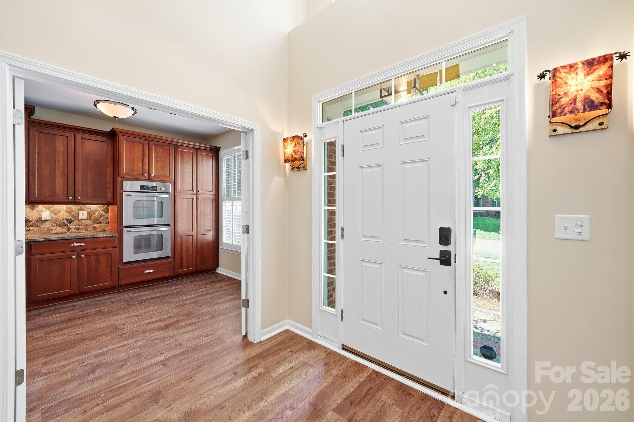 Foyer with custom sconces. - Charlotte