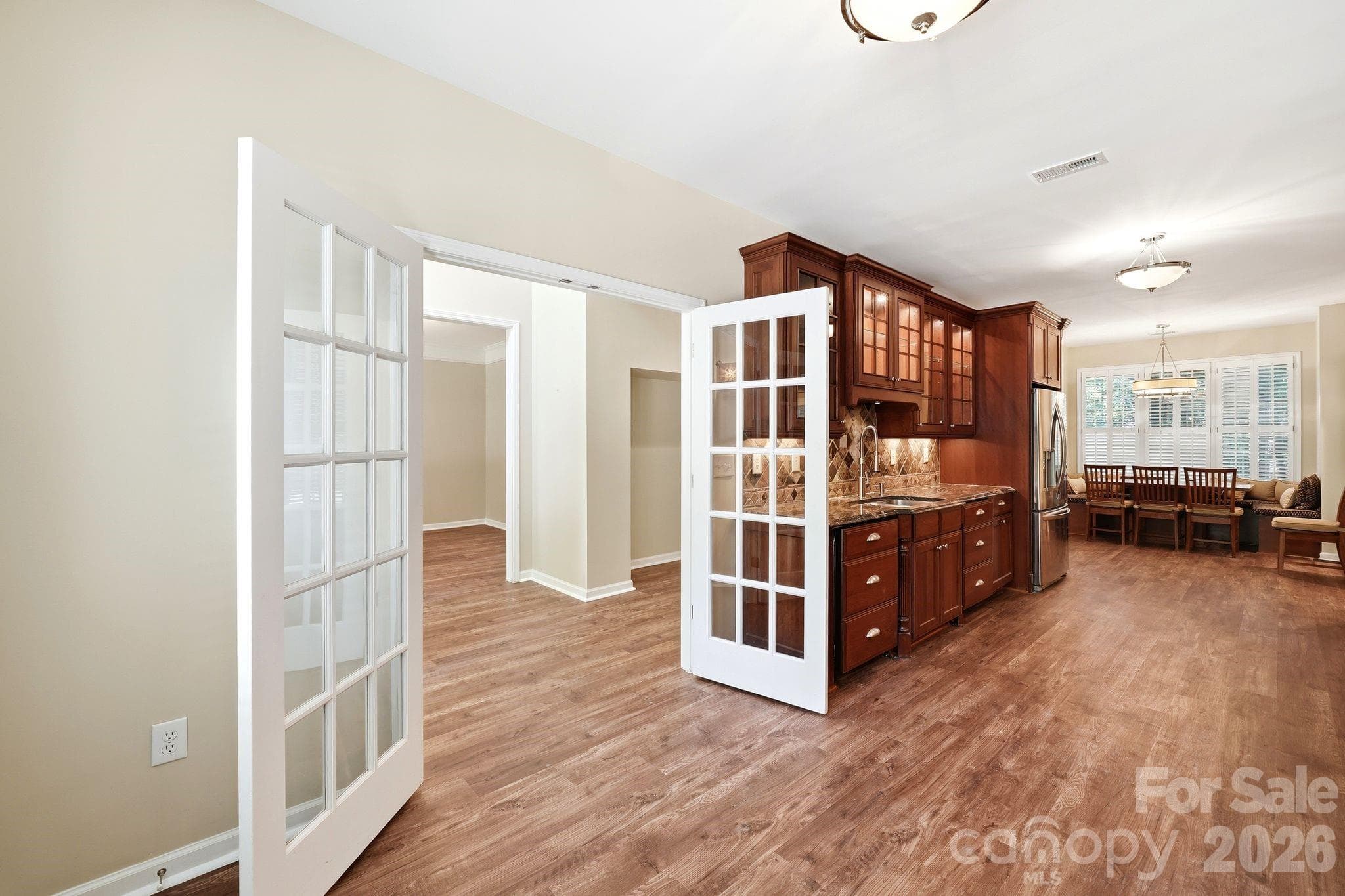 French doors welcome you into the custom kitchen. - Charlotte