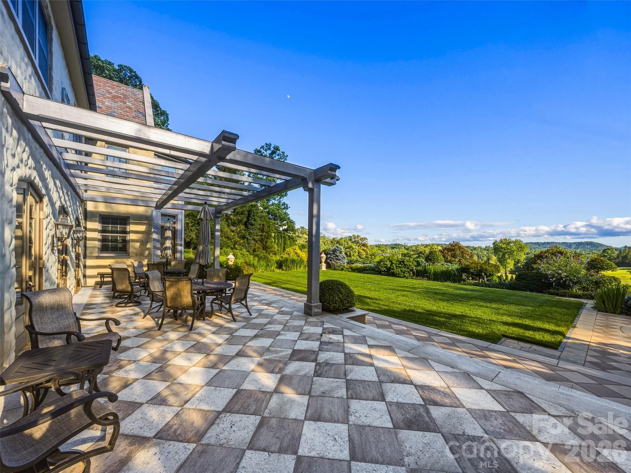 Terraces and covered porches surround the home for splendid entertaining - Biltmore Forest