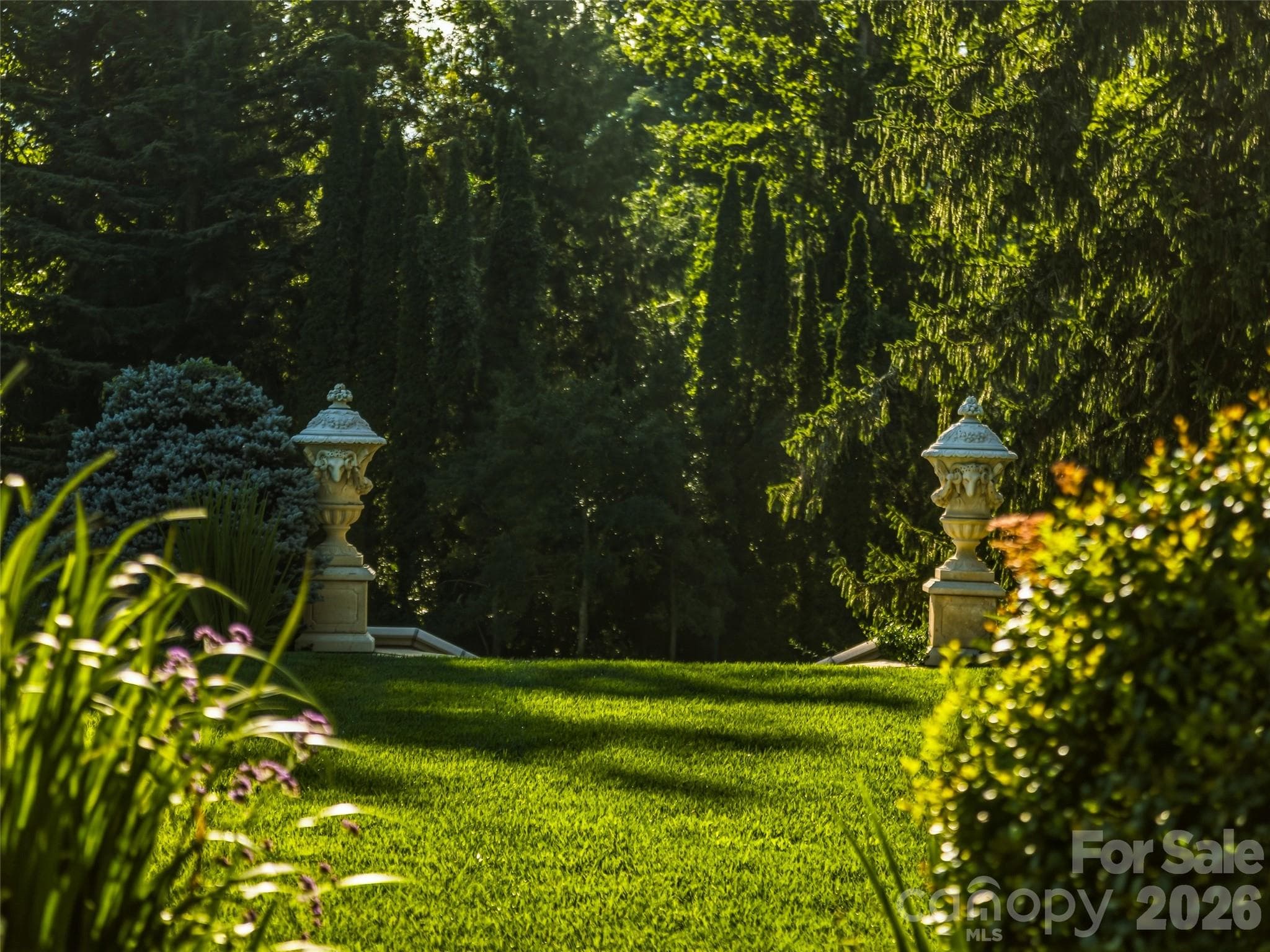 Set amidst towering oaks and old growth conifers the light and shadow of the sun creates areas of warmth and cooling shade. - Biltmore Forest