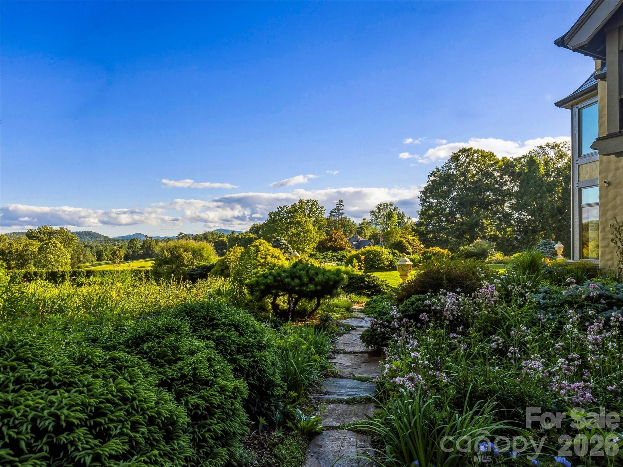 The secret garden overflowing with perennials bathed in evening light - Biltmore Forest