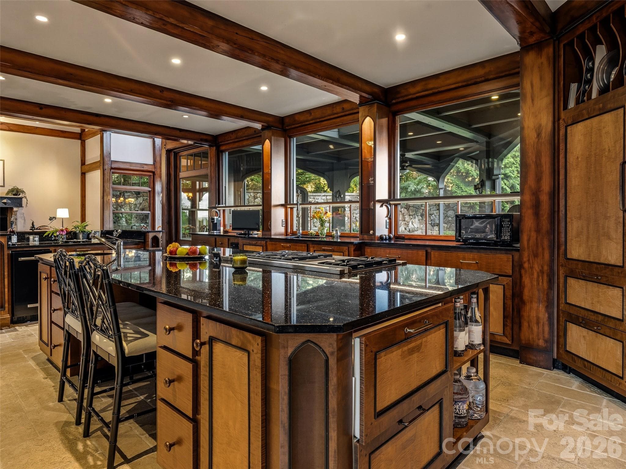 Copious windows bring  the views into the kitchen/ great room. - Biltmore Forest