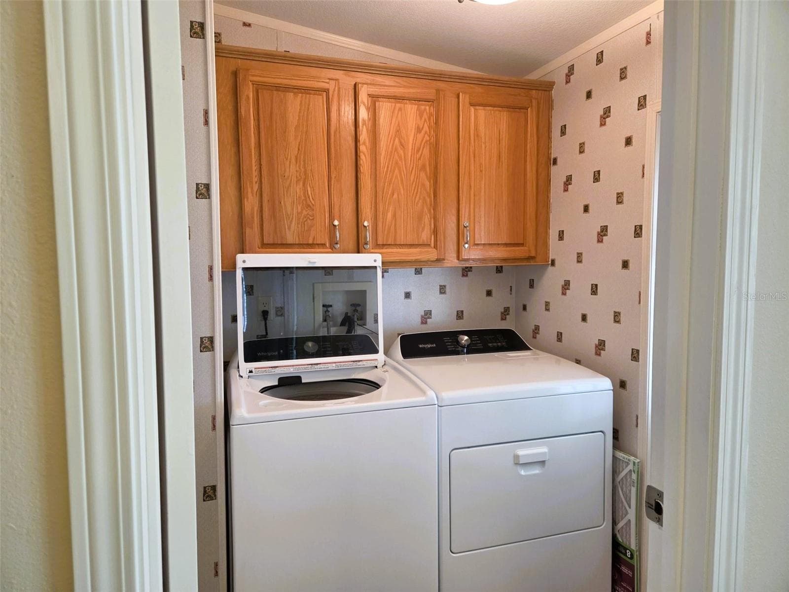 Inside Laundry Room with Utility tub and cabinet space for storage - 3324 OVERCUP OAK TER, SARASOTA