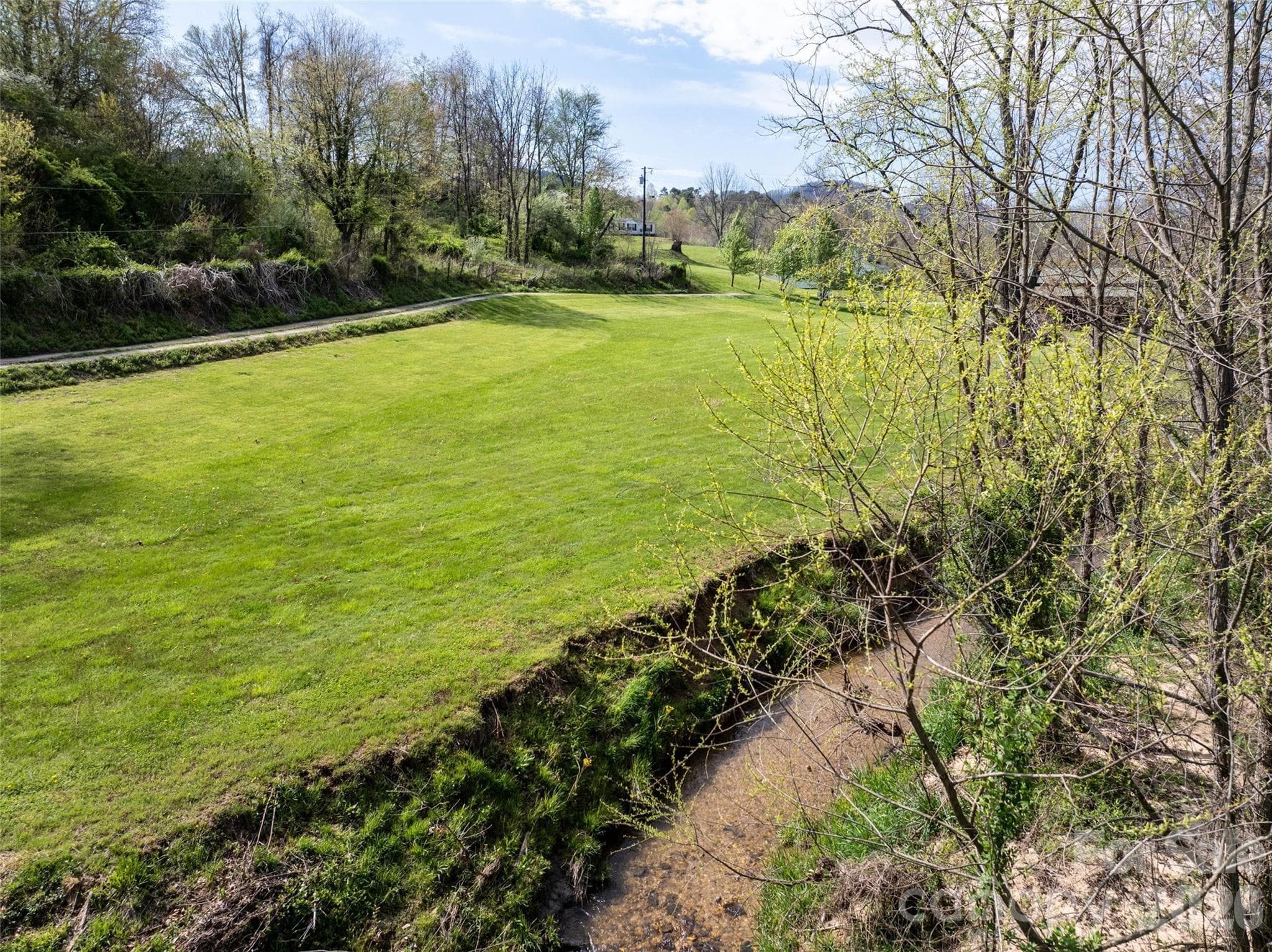 Flat buildable topography bordering a creek. - Asheville