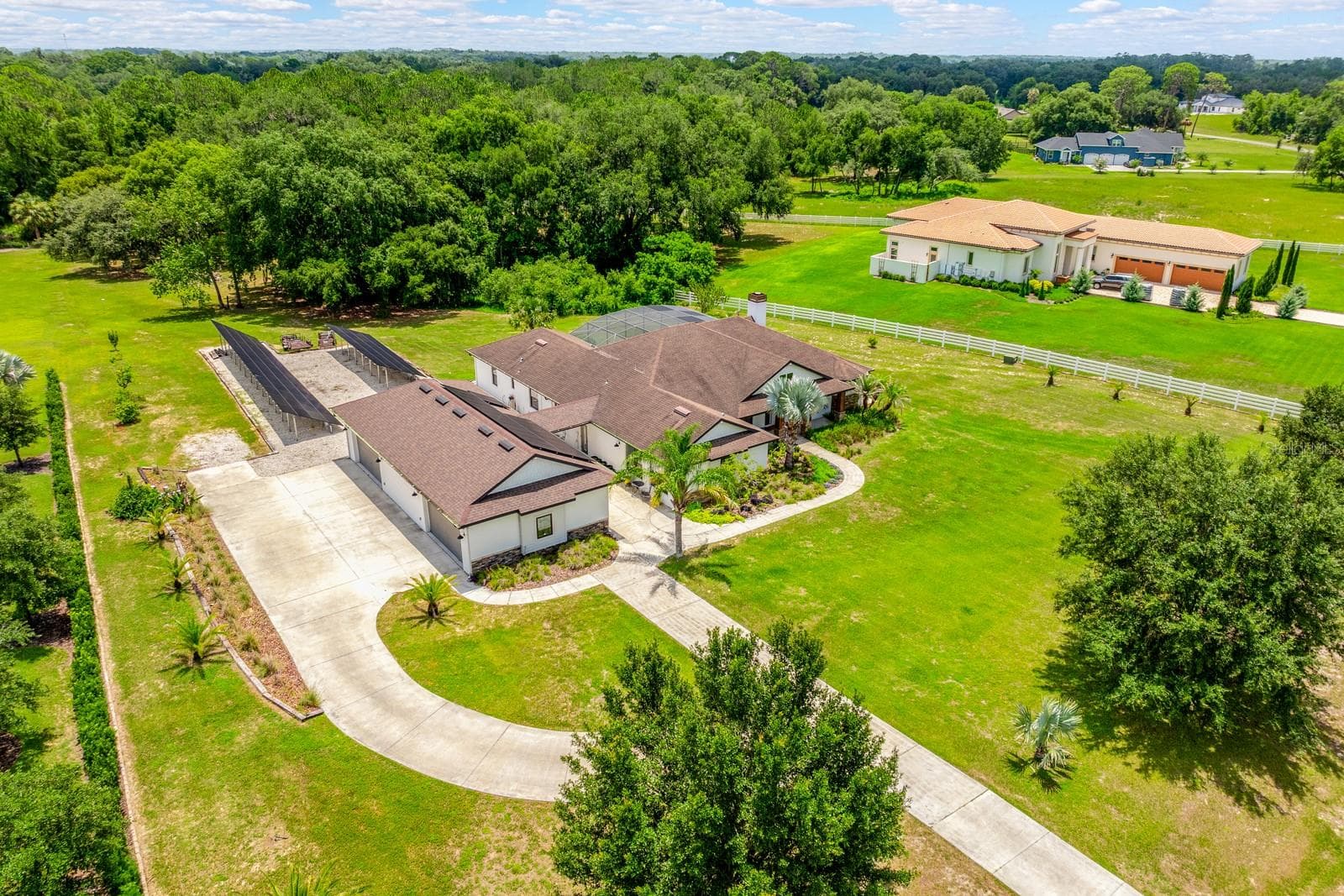Set on 2.32 PICTURESQUE ACRES inside the GATED ~ EQUESTRIAN COMMUNITY of Beauclair Ranch Club, this CUSTOM BUILT ~ 6-bedroom / 4-bath ~ POOL HOME with a 4-car detached garage offers the perfect blend of privacy, luxury, and energy-efficient living! - 27324 GRAND OAK LN, TAVARES