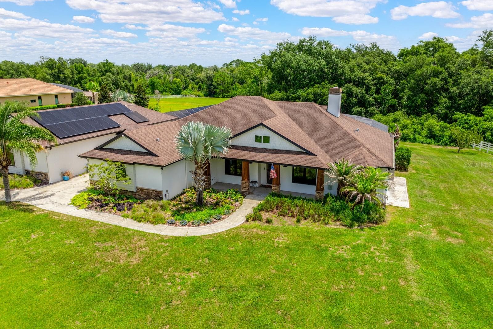 Set on 2.32 PICTURESQUE ACRES inside the GATED ~ EQUESTRIAN COMMUNITY of Beauclair Ranch Club, this CUSTOM BUILT ~ 6-bedroom / 4-bath ~ POOL HOME with a 4-car detached garage offers the perfect blend of privacy, luxury, and energy-efficient living! - 27324 GRAND OAK LN, TAVARES