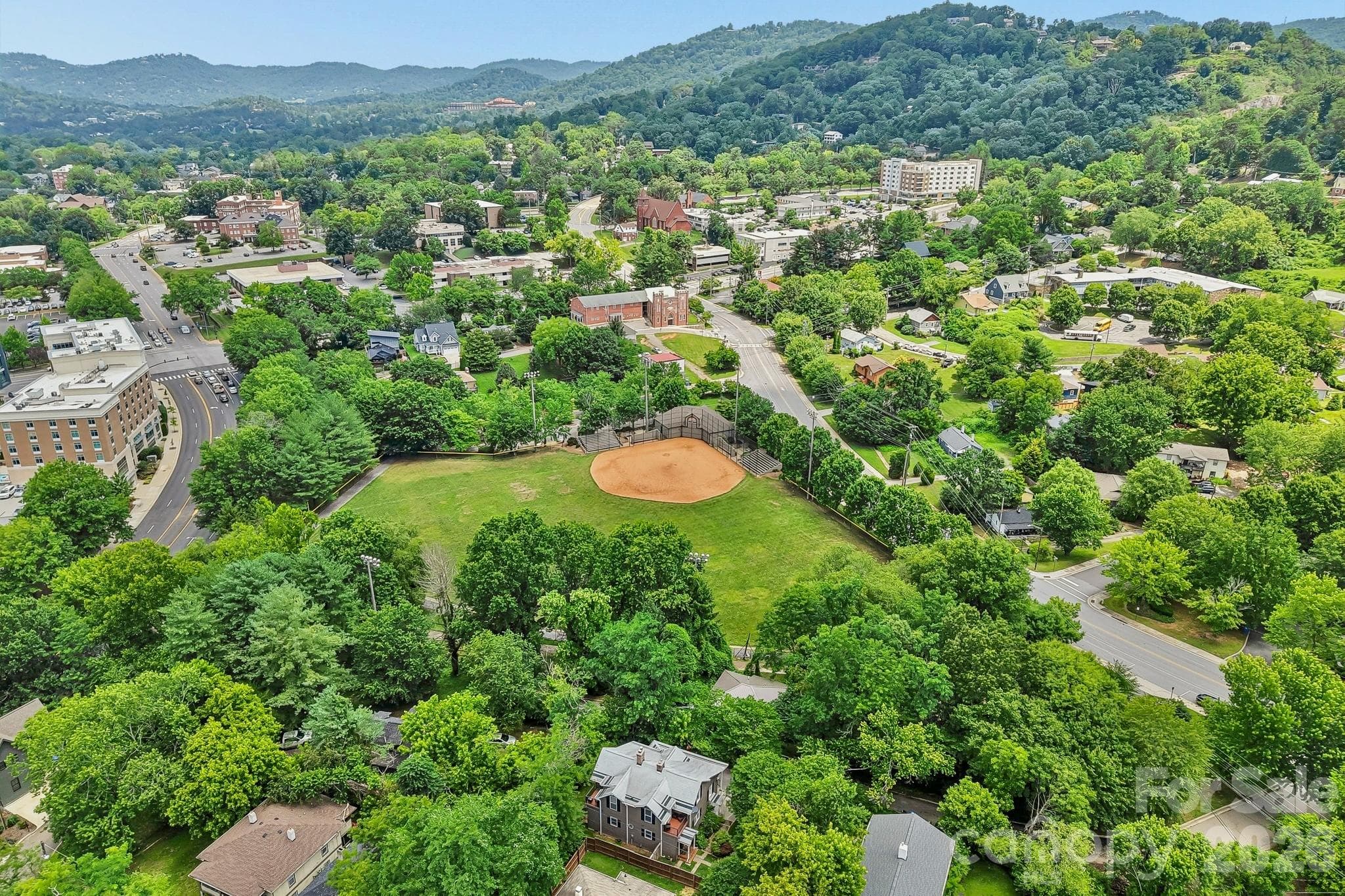 Aerial view showing field next door and mountains - 23 Tuskeegee Street, Asheville