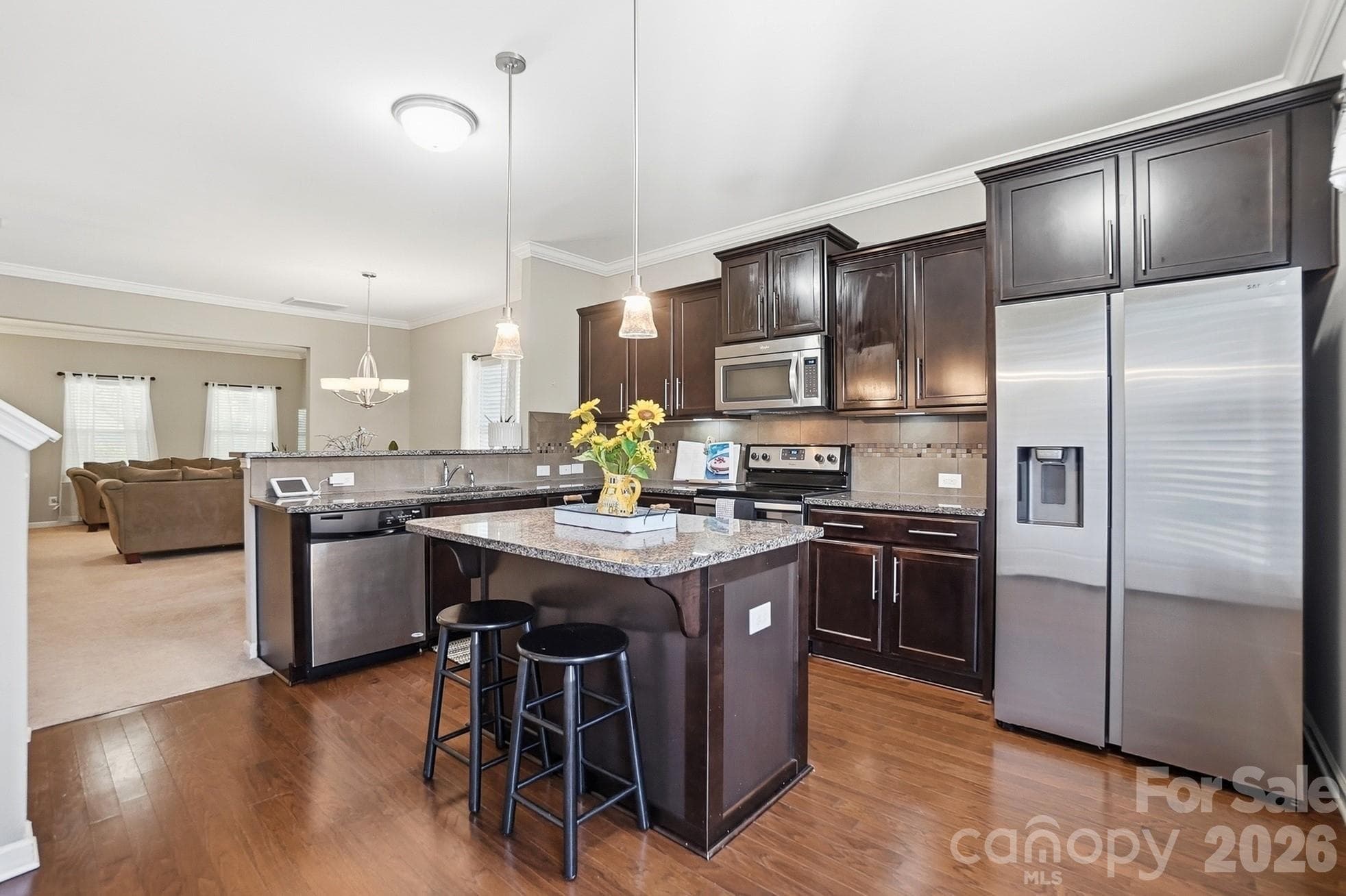 Open kitchen with center island and easy flow to the main living areas. - Huntersville
