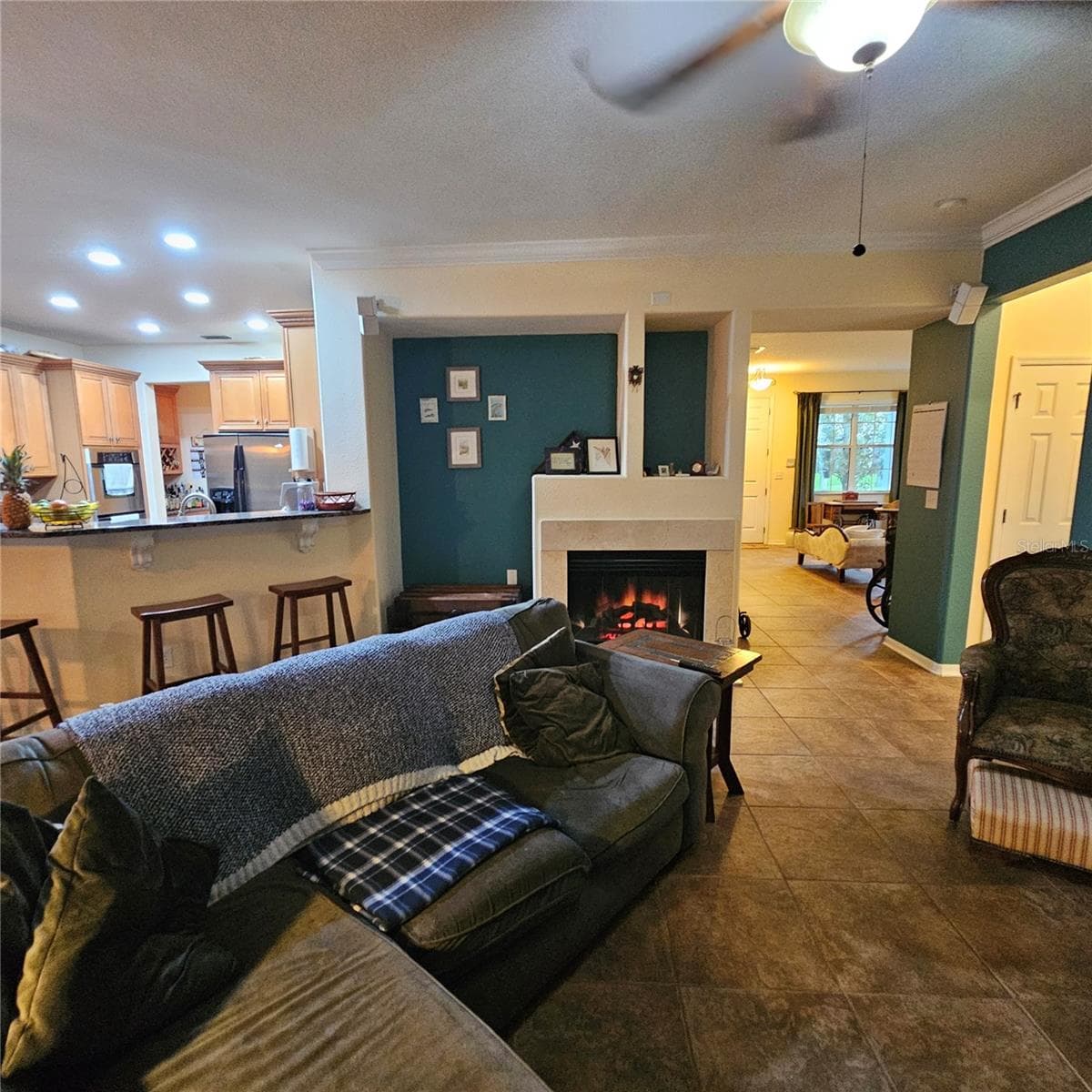 Fireplace giving the Living area  a warm glow - 7306 BRIDGEVIEW DR, WESLEY CHAPEL