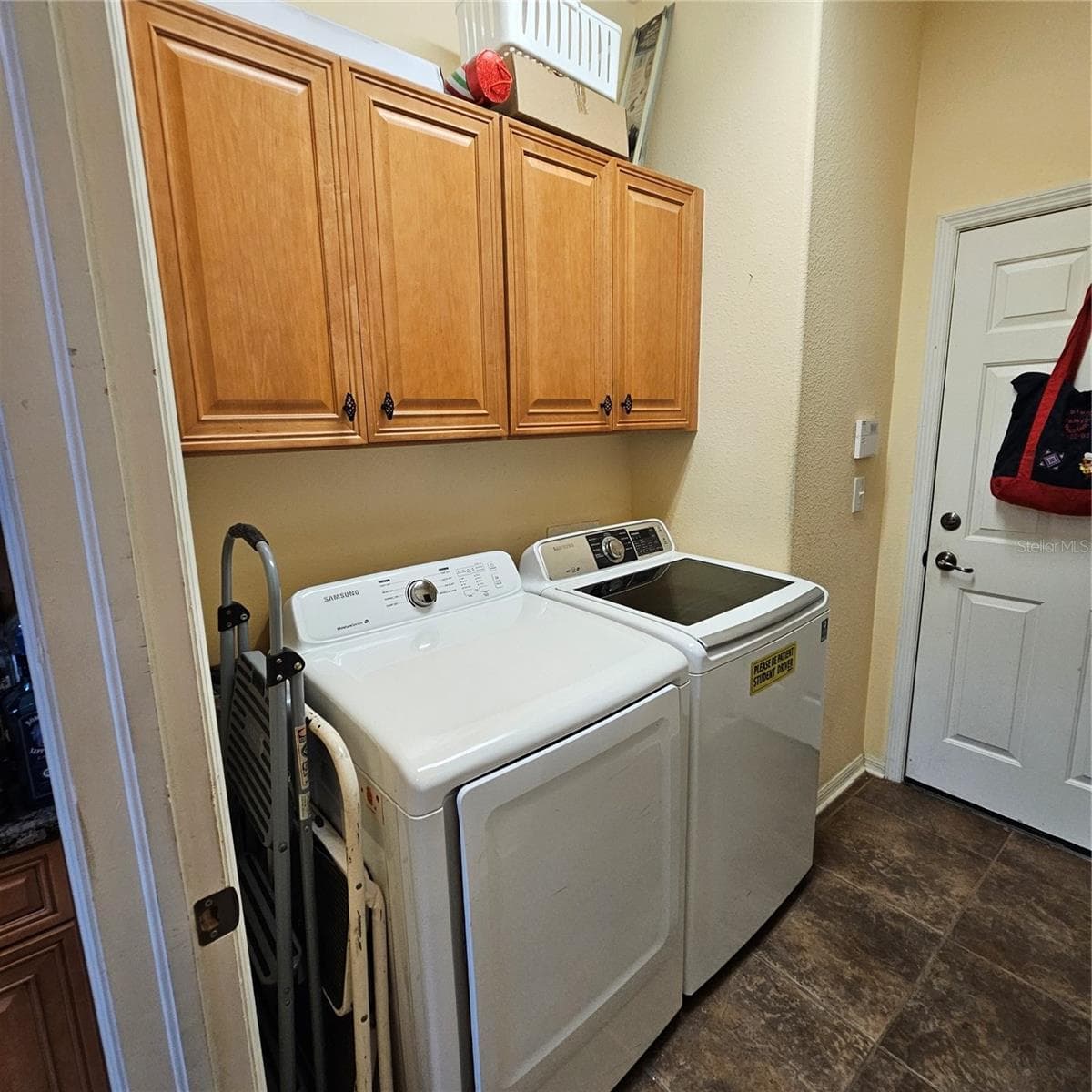Inside Laundry room with storage - 7306 BRIDGEVIEW DR, WESLEY CHAPEL