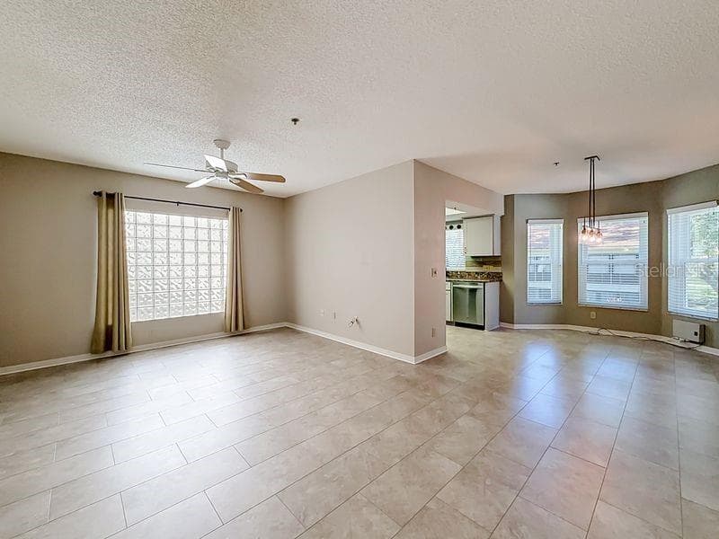 Spacious living room looking into dining area and kitchen - 2210 UTOPIAN DR E #214, CLEARWATER
