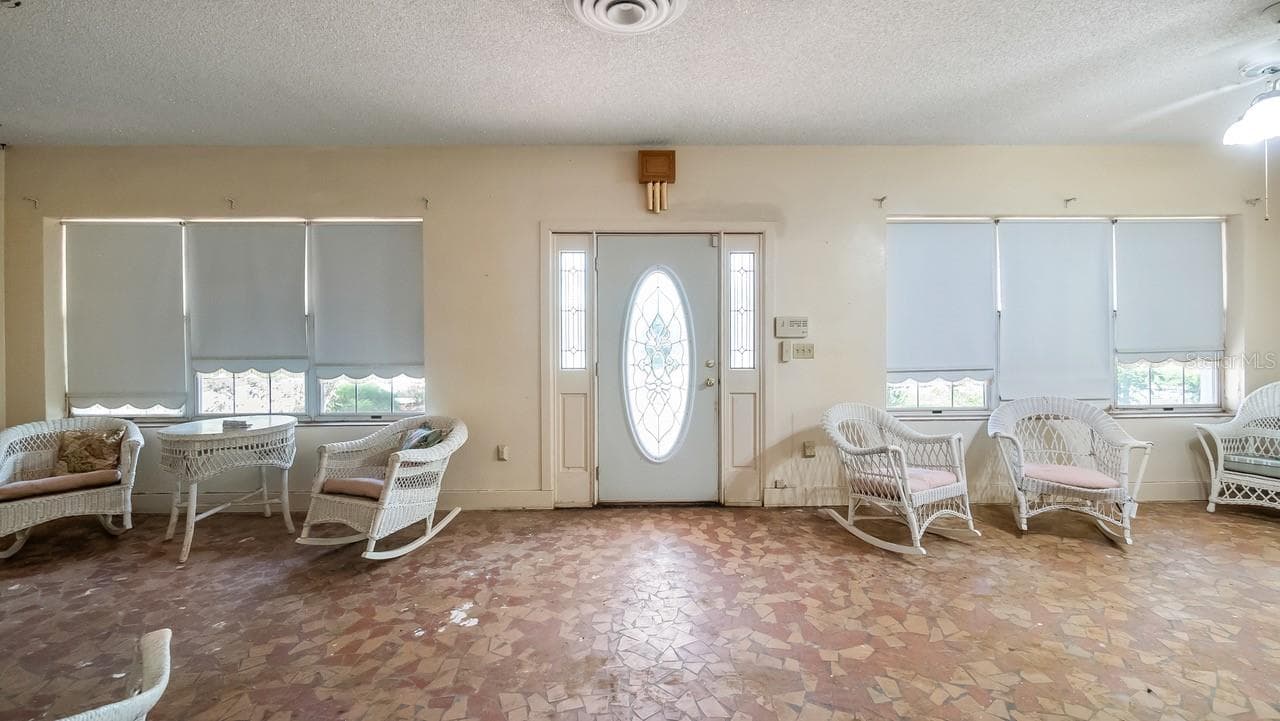 Front enclosed porch with terrazzo flooring - 127 E LAUREL AVE, HOWEY IN THE HILLS