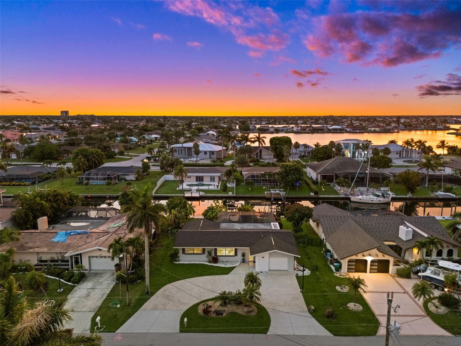 Aerial Evening View of the house - 5122 SW 3RD AVE, CAPE CORAL
