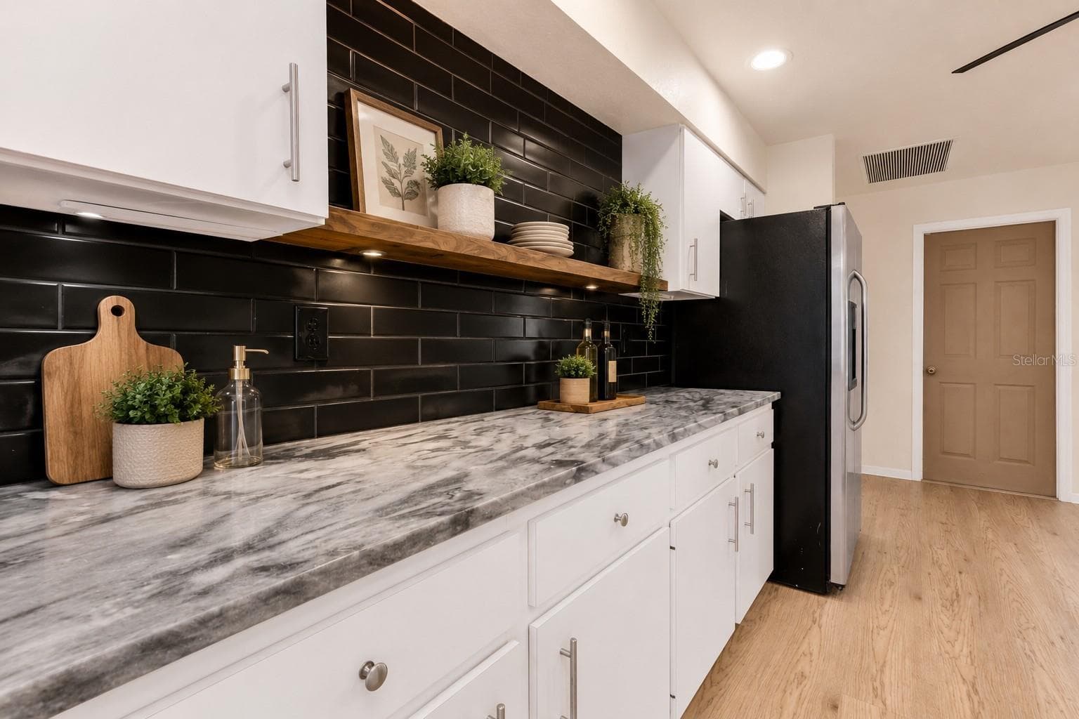 Granite kitchen counter tops with tall white cabinetry. - 297 FLAMINGO BLVD, PORT CHARLOTTE