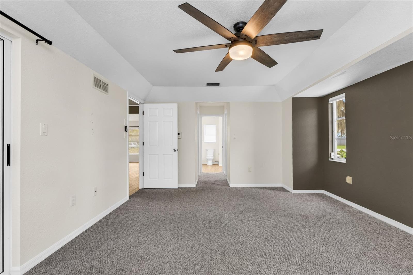 Primary bedroom with hallway to dual walk in closets and ensuite bathroom - 297 FLAMINGO BLVD, PORT CHARLOTTE