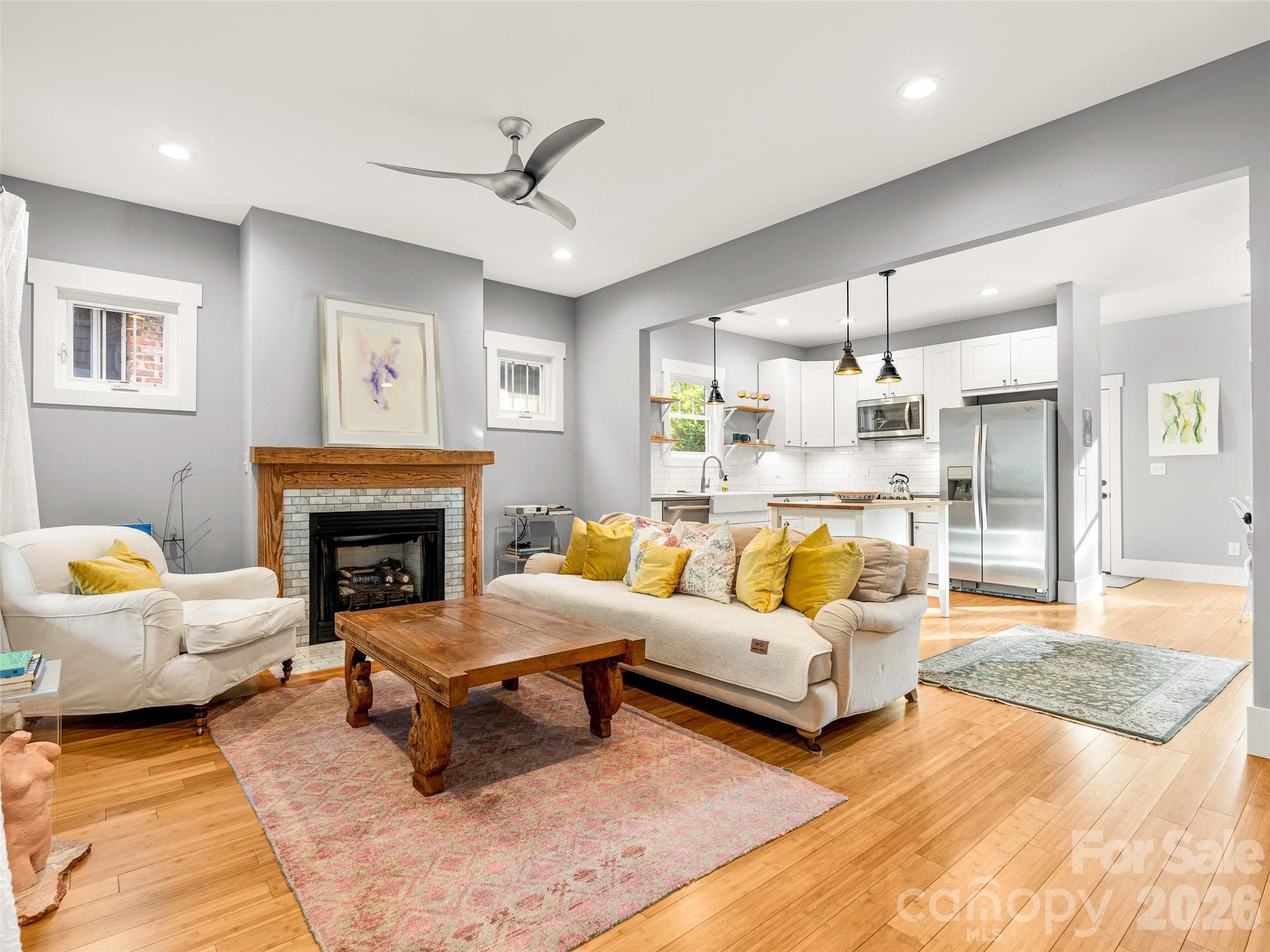 Gas buring fireplace with reclaimed wood surround and bamboo floors. - 60 Mardell Circle, Asheville