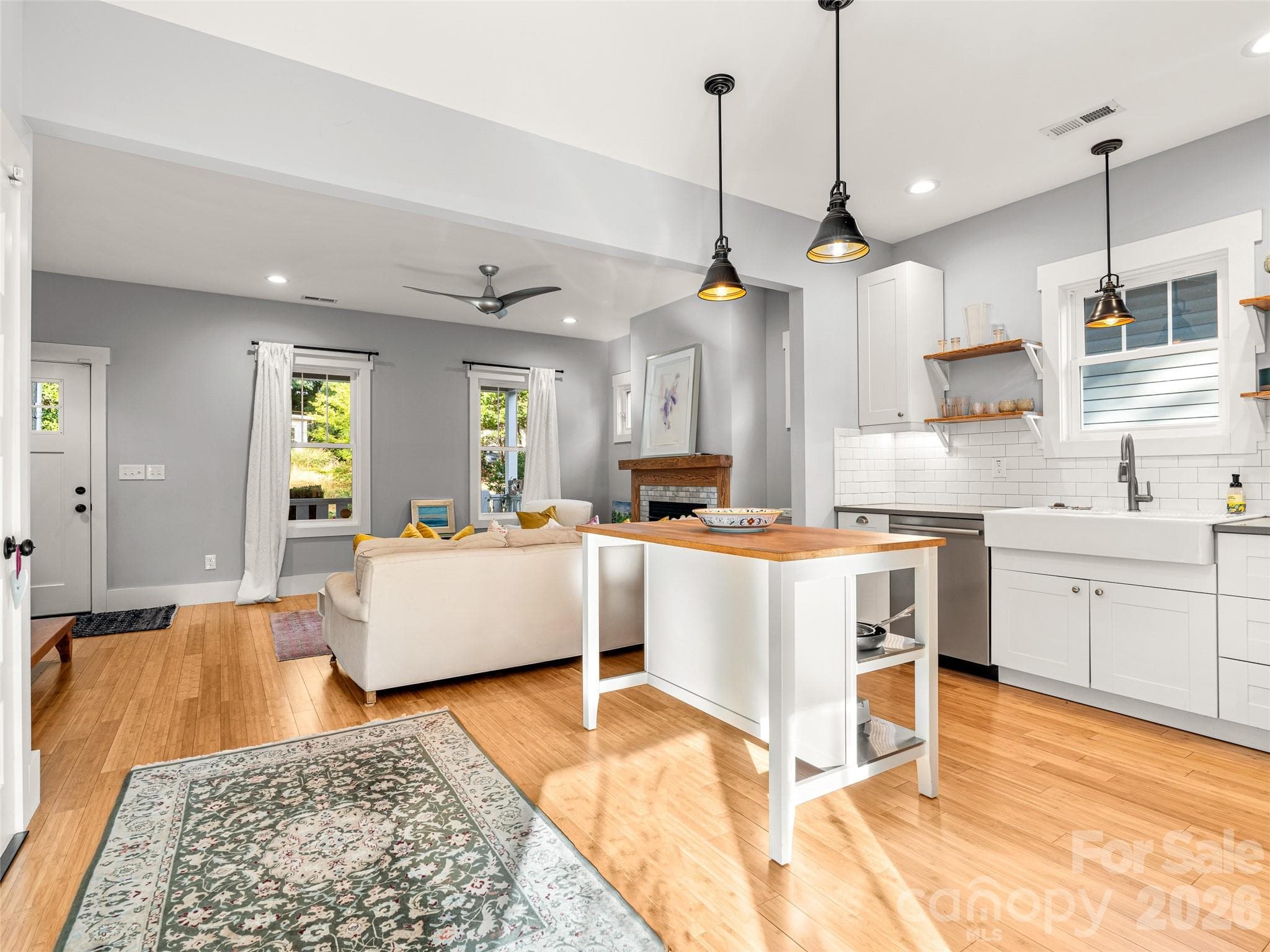 Open concept kitchen to living room with natural light pouring in. - 60 Mardell Circle, Asheville