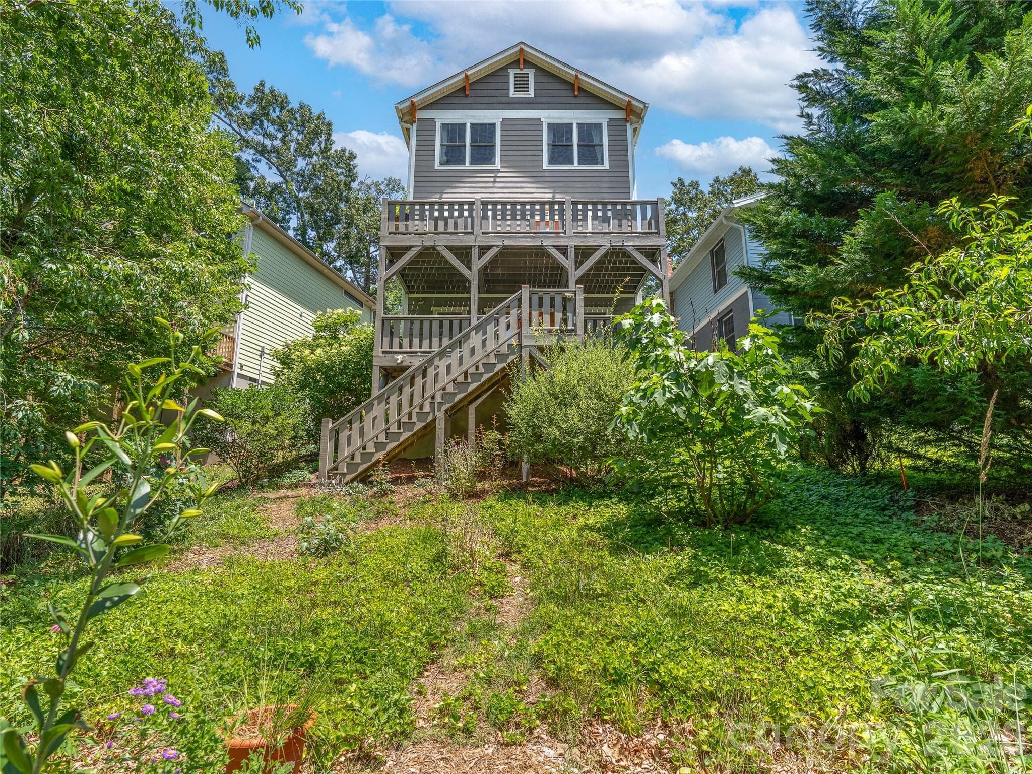 Back view of home with ample backyard. - 60 Mardell Circle, Asheville