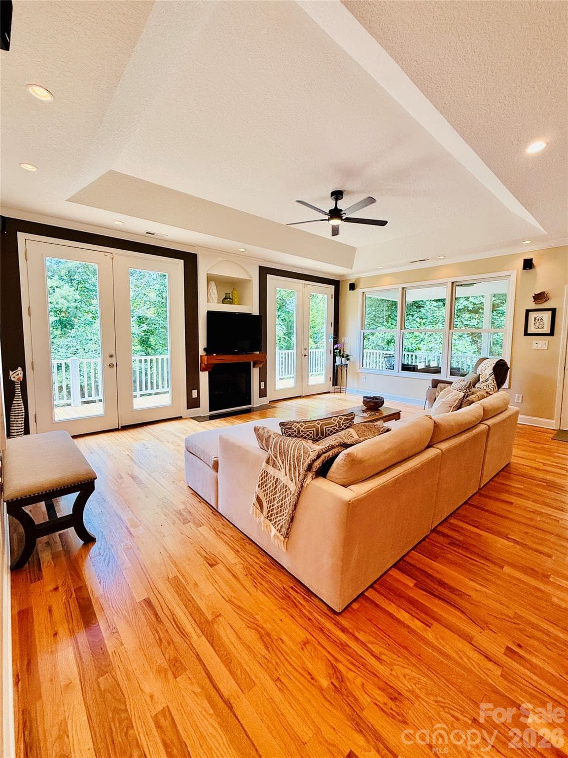The living room brings the outdoors in with abundant windows and tall French doors - Weaverville
