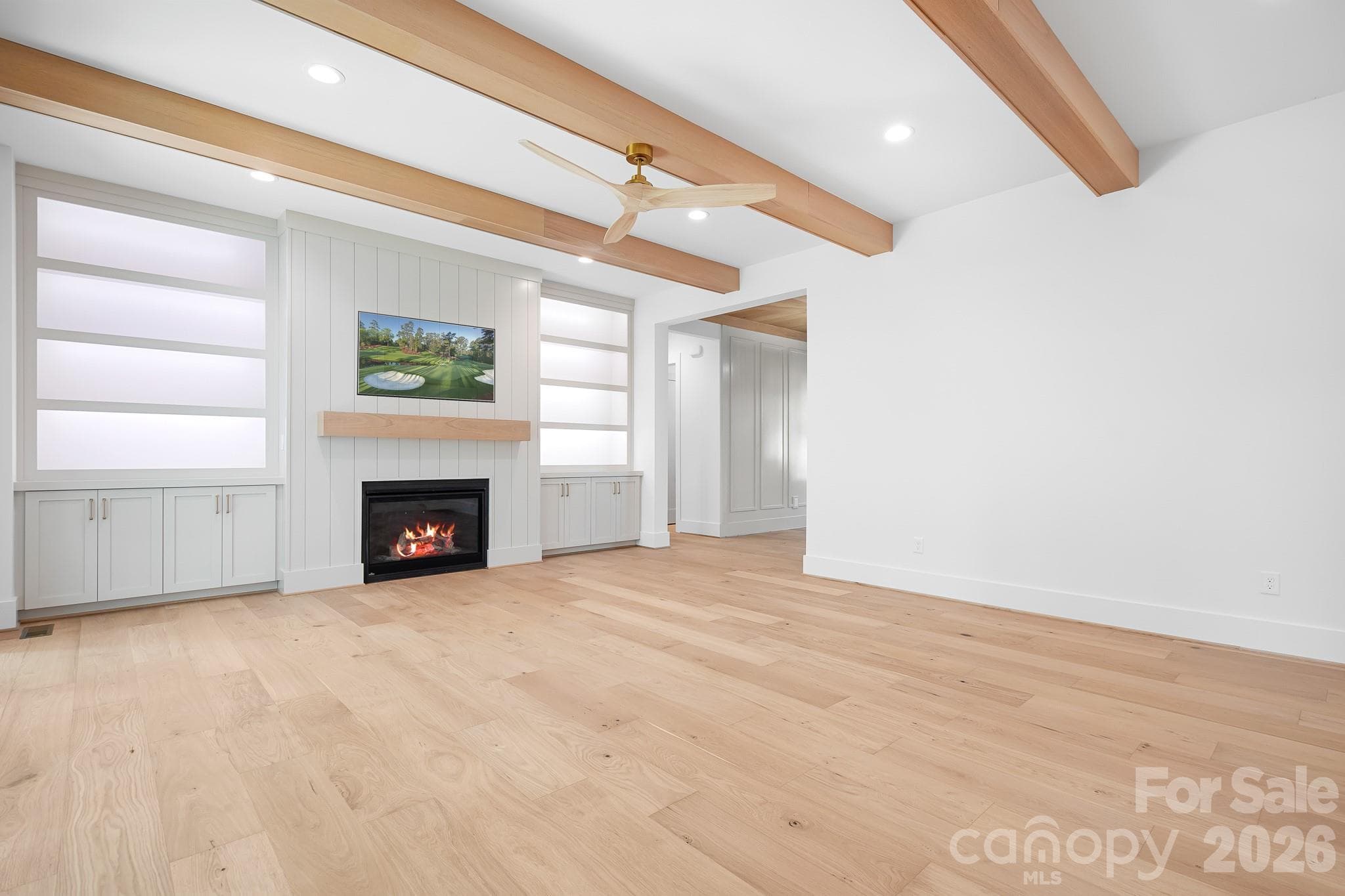 Family Room with lit Built-ins and beam ceiling - Mooresville