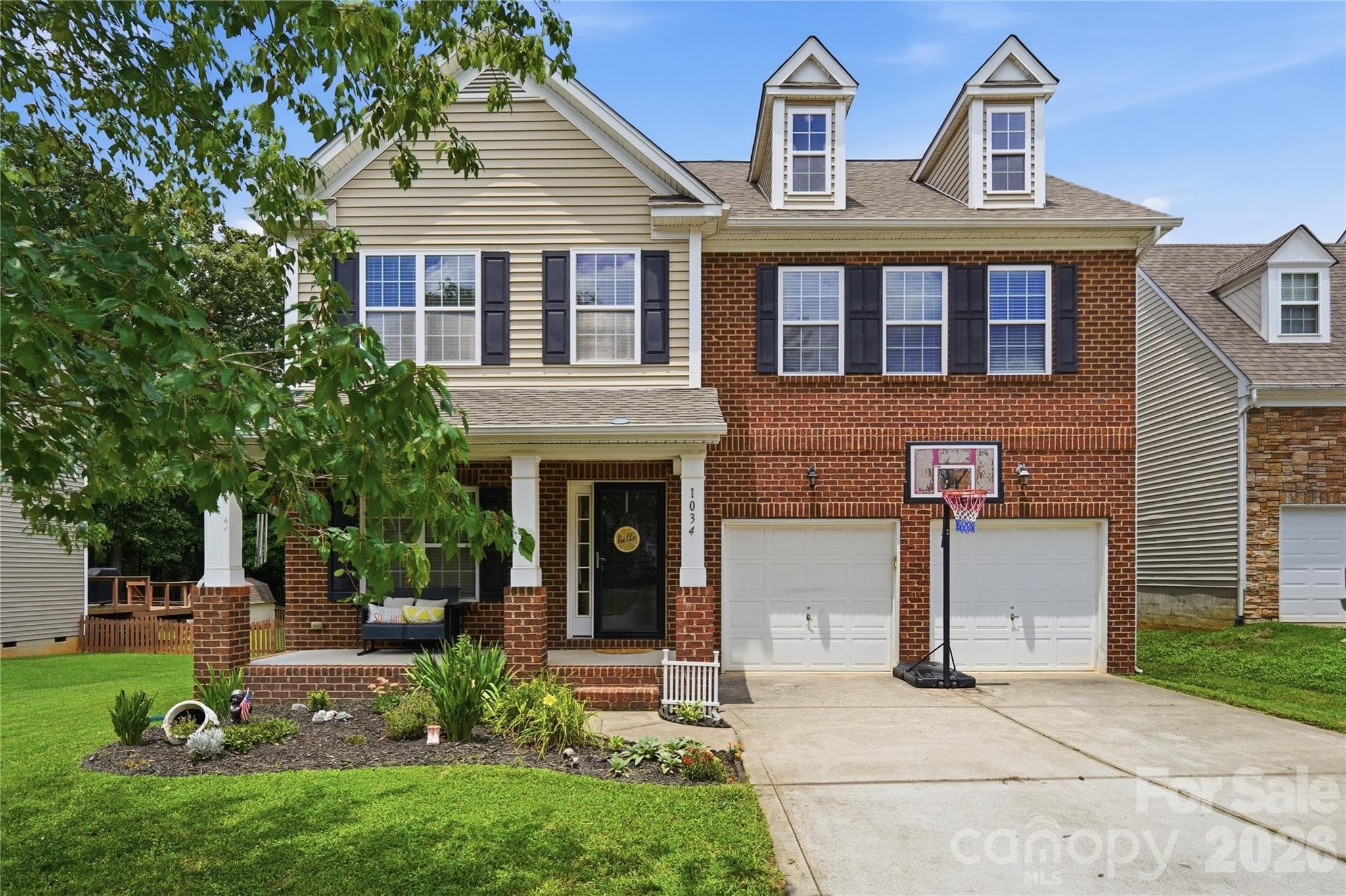 Classic brick-front curb appeal with a welcoming covered porch - Indian Trail