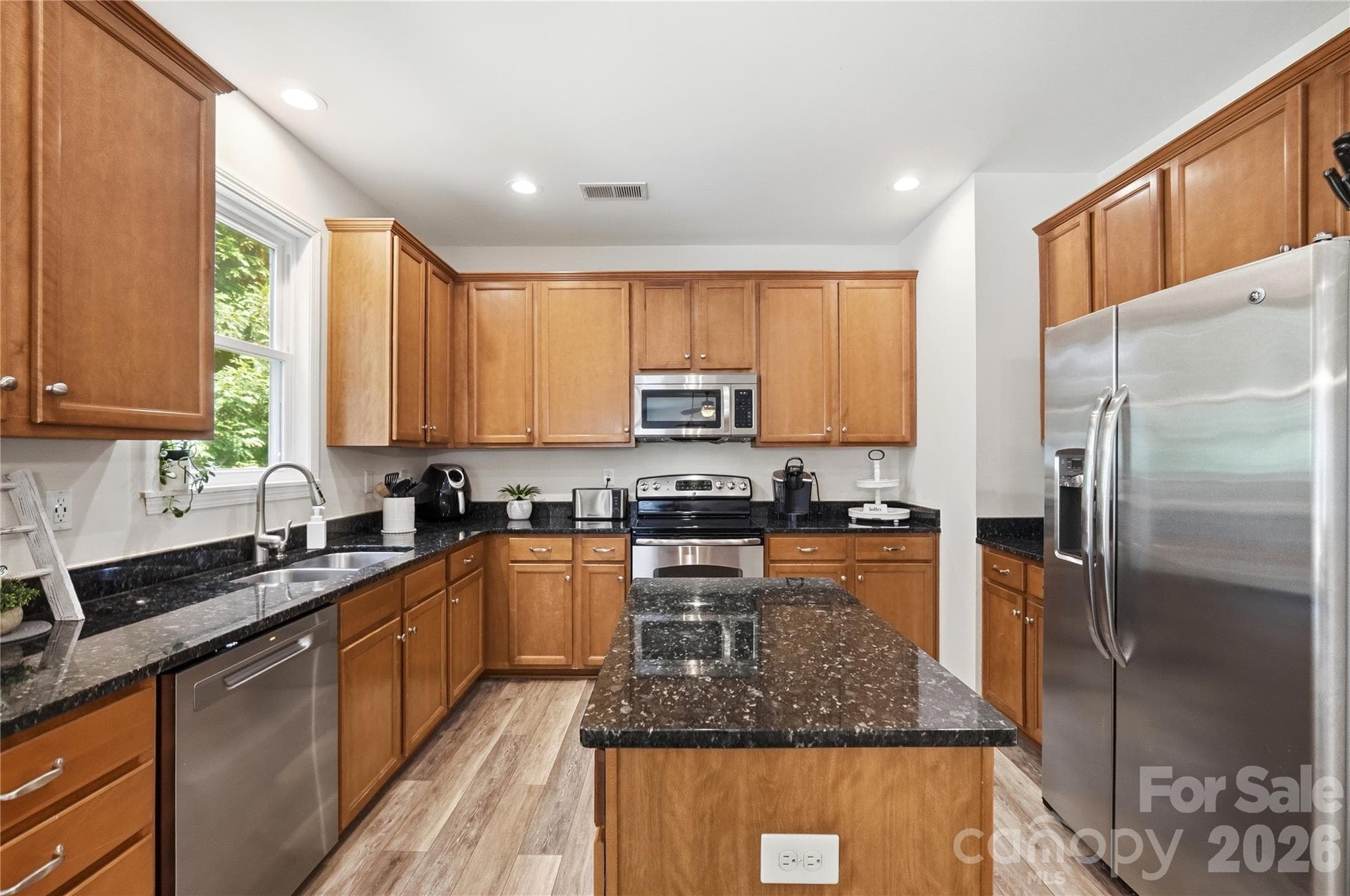 Warm wood cabinetry and stainless steel appliances - Indian Trail