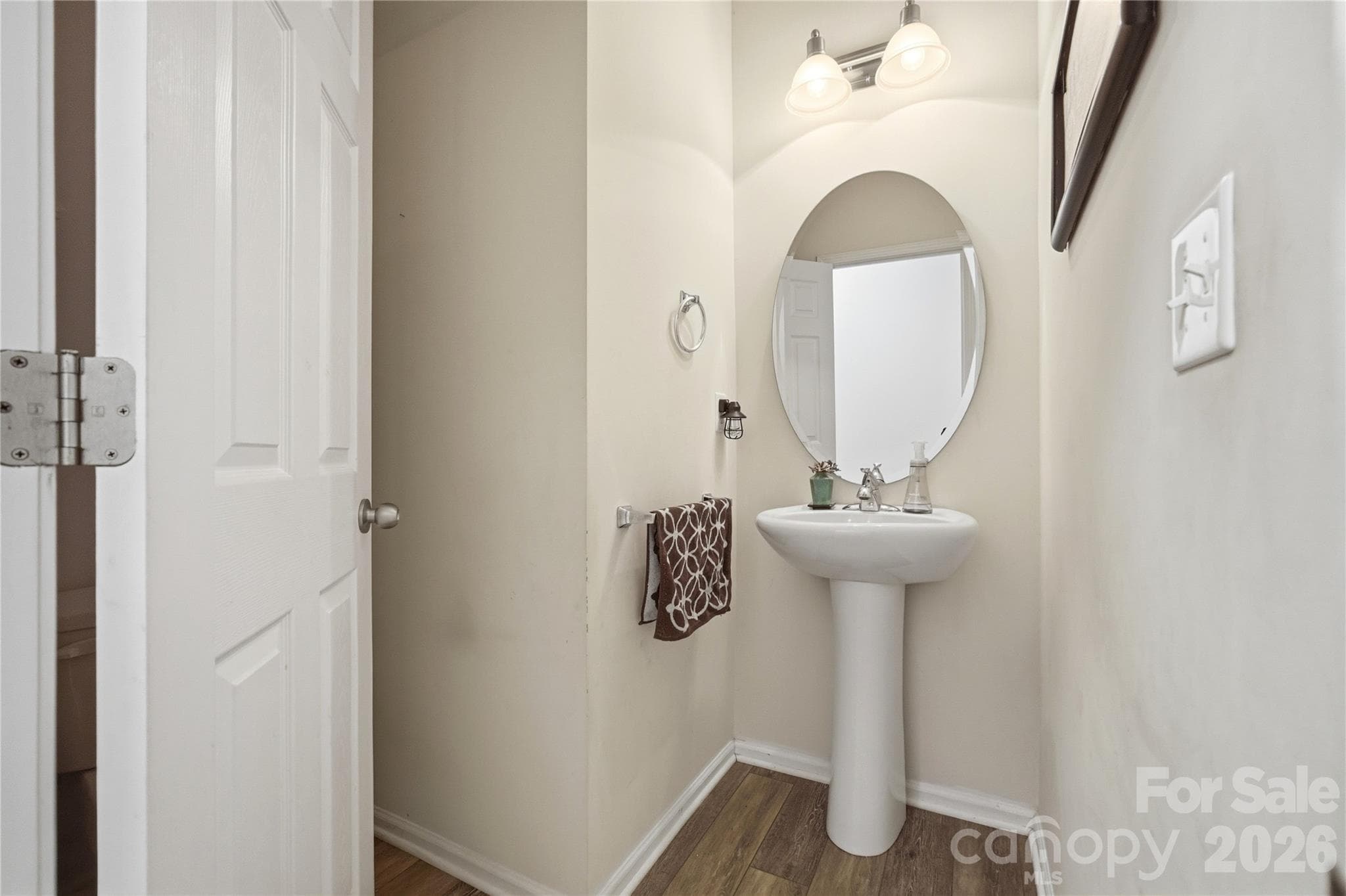 Convenient powder room with a stylish pedestal sink - Indian Trail
