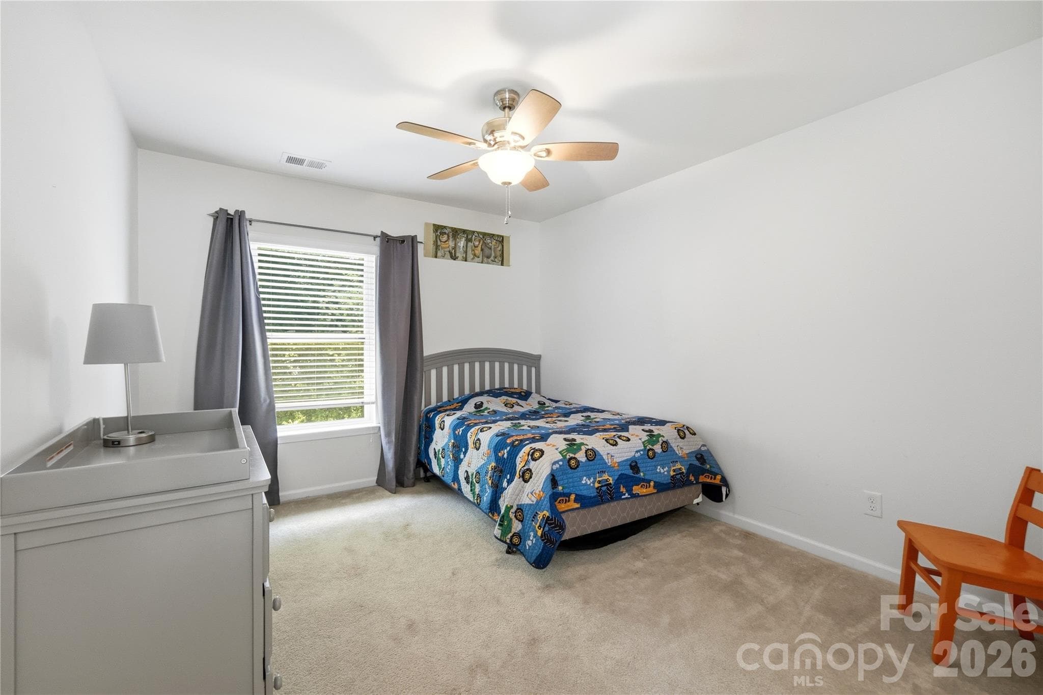 Comfortable guest bedroom with cozy carpet and a bright window - Indian Trail
