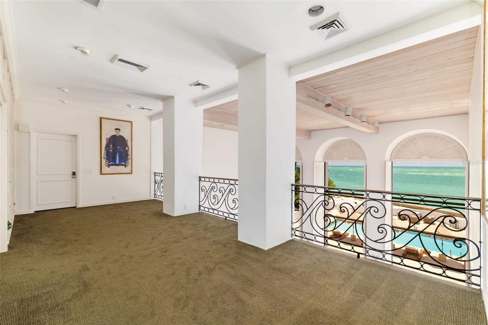 Primary Bedroom with ensuite and walk-in closets behind closed door, walk out terraces overlooking ocean. There is great wall space throughout the home for displays of art collections - 1157 WESTWAY DR, SARASOTA
