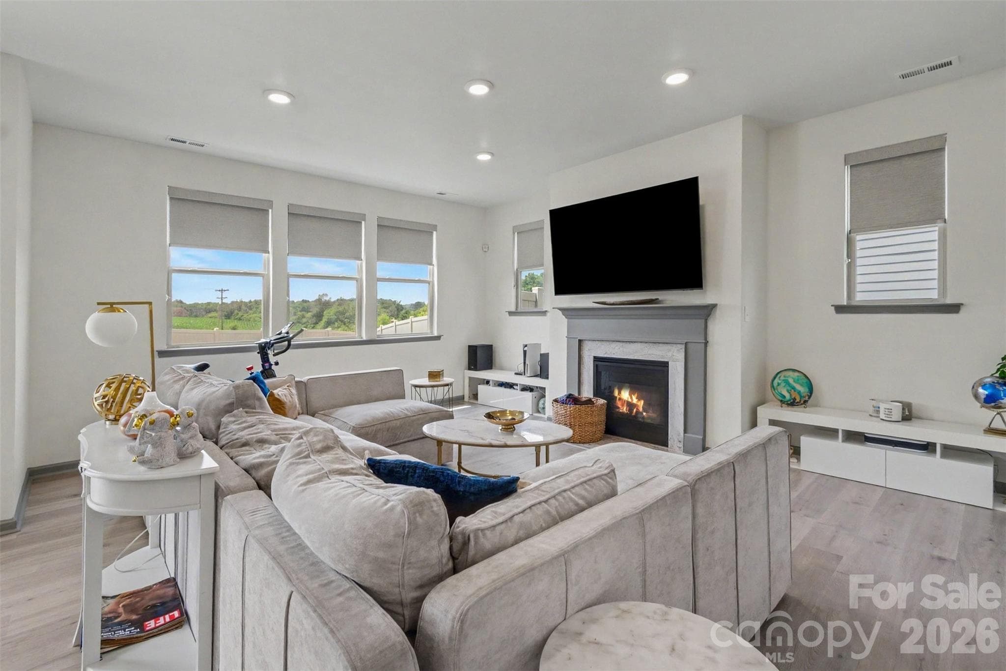 The great room is light and bright with lots of recessed lighting and a beautiful gas fireplace. - 2055 Yearden Lane, Monroe