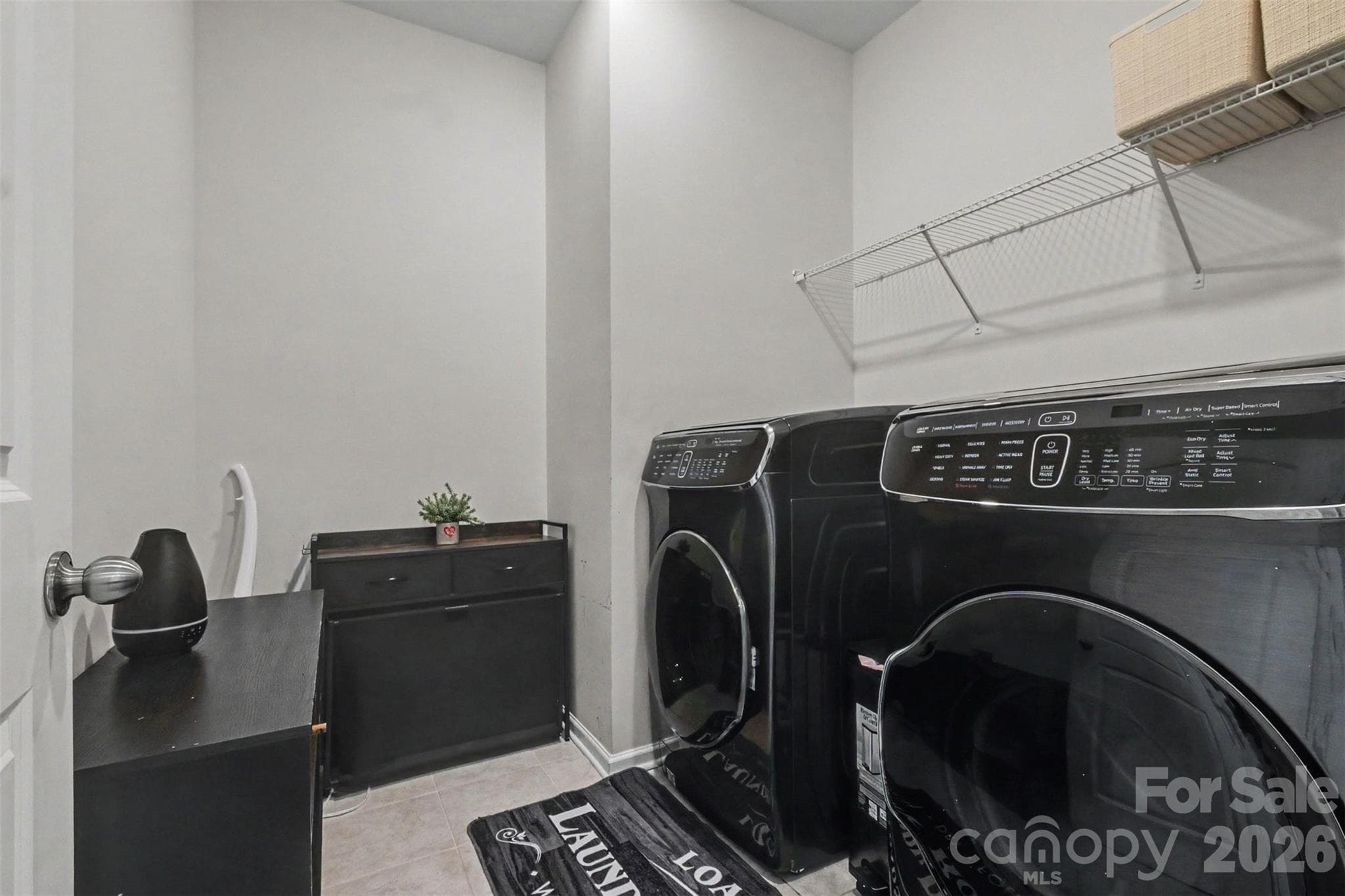 The upstairs laundry room features tiled flooring and recessed lighting. - 2055 Yearden Lane, Monroe
