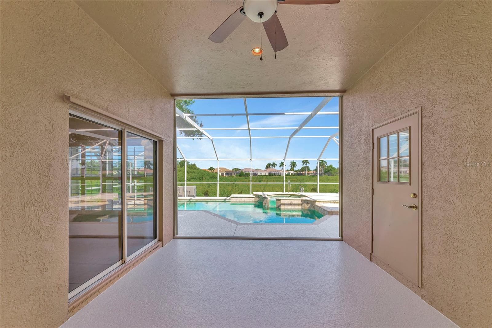 Deep covered lanai w/ view to pool & spa. - 5133 FLAGSTONE DR, SARASOTA