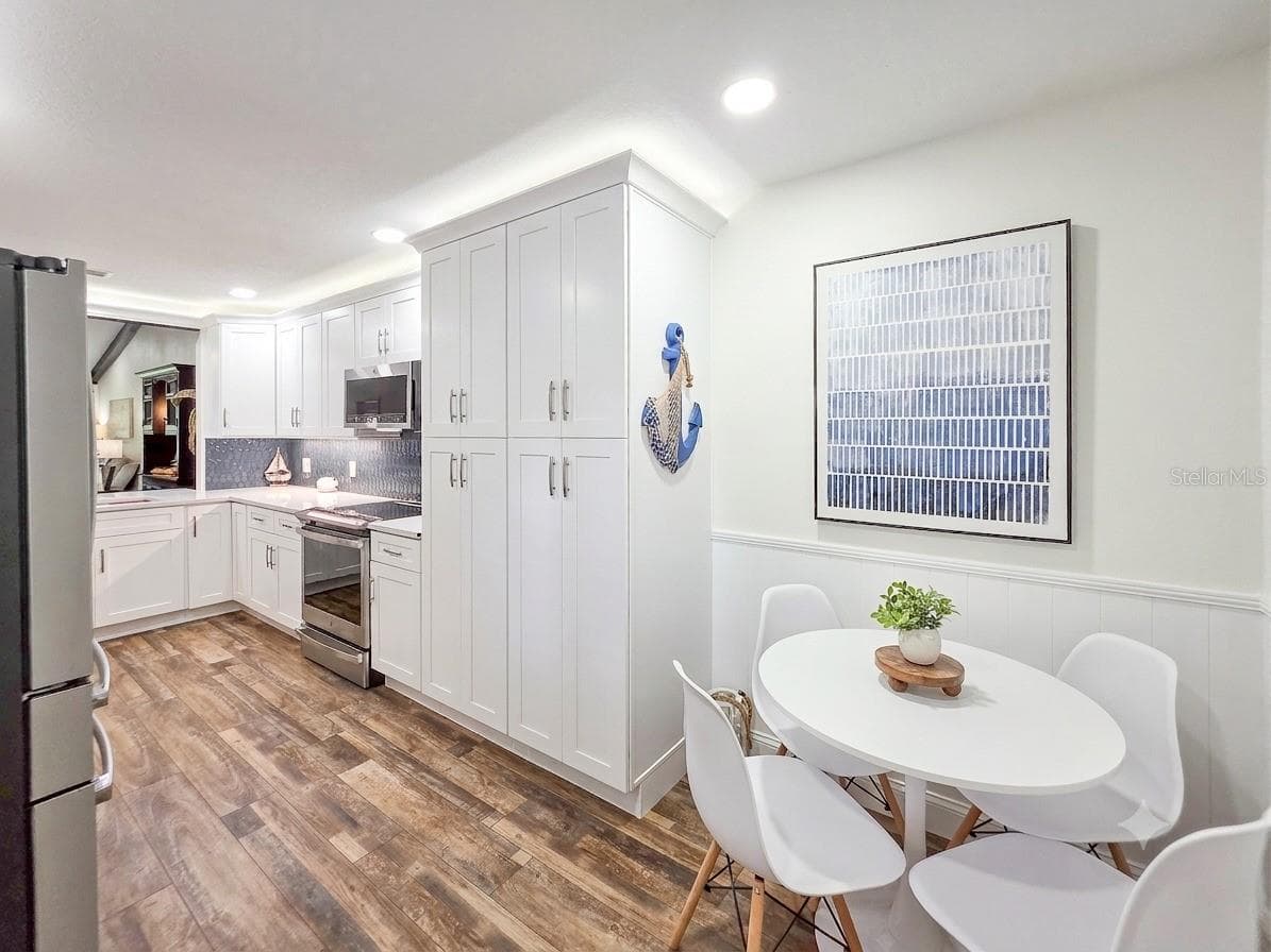 Breakfast nook with coastal wainscot detail. - 100 SEA PINES CIR, DAYTONA BEACH