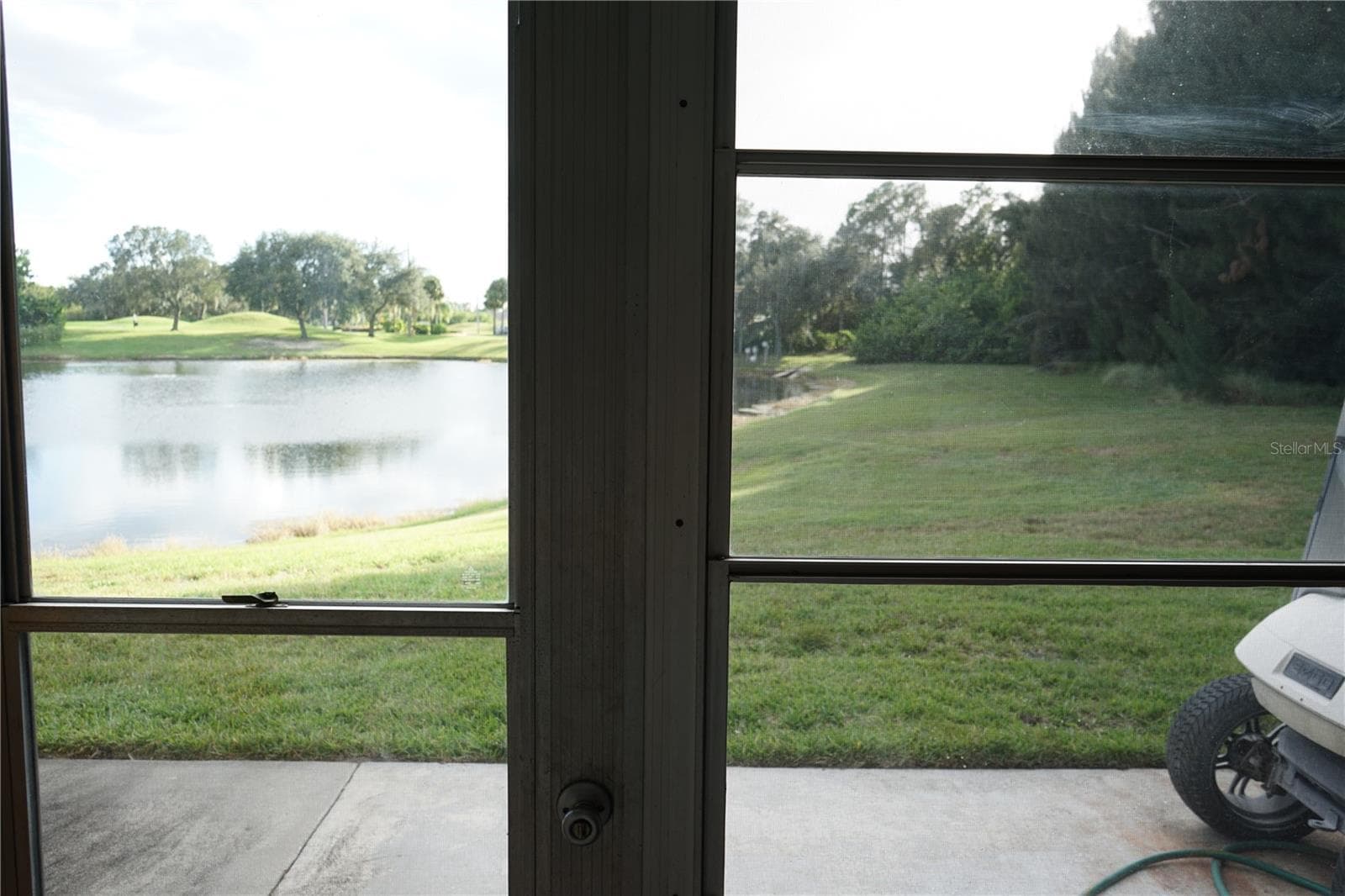 lanai has glass windows and a pond view - 424 LAKE POINT CT #5A, SUN CITY CENTER