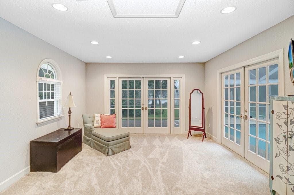 Master bedroom has large sitting area with French doors to pool/patio area. This area can also be used for yoga,or office space etc. - 1976 DUNLOE CIR, DUNEDIN
