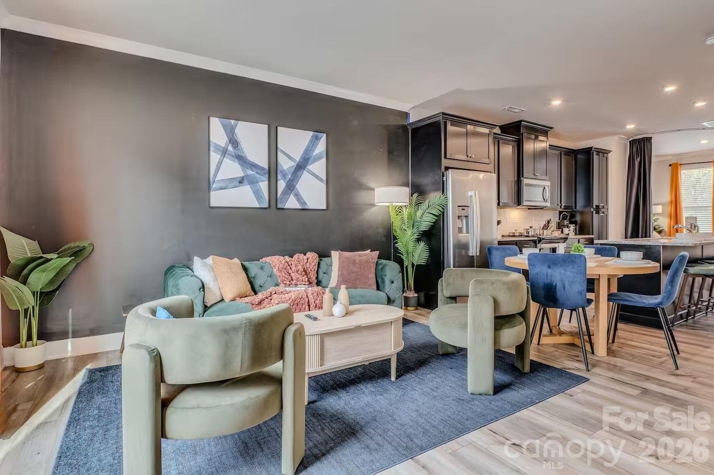 The inviting living room features abundant natural light, stylish modern finishes, and an open-concept design that flows seamlessly to the private balcony, creating the perfect space for relaxing or entertaining. - 3019 Jolene Court, Charlotte