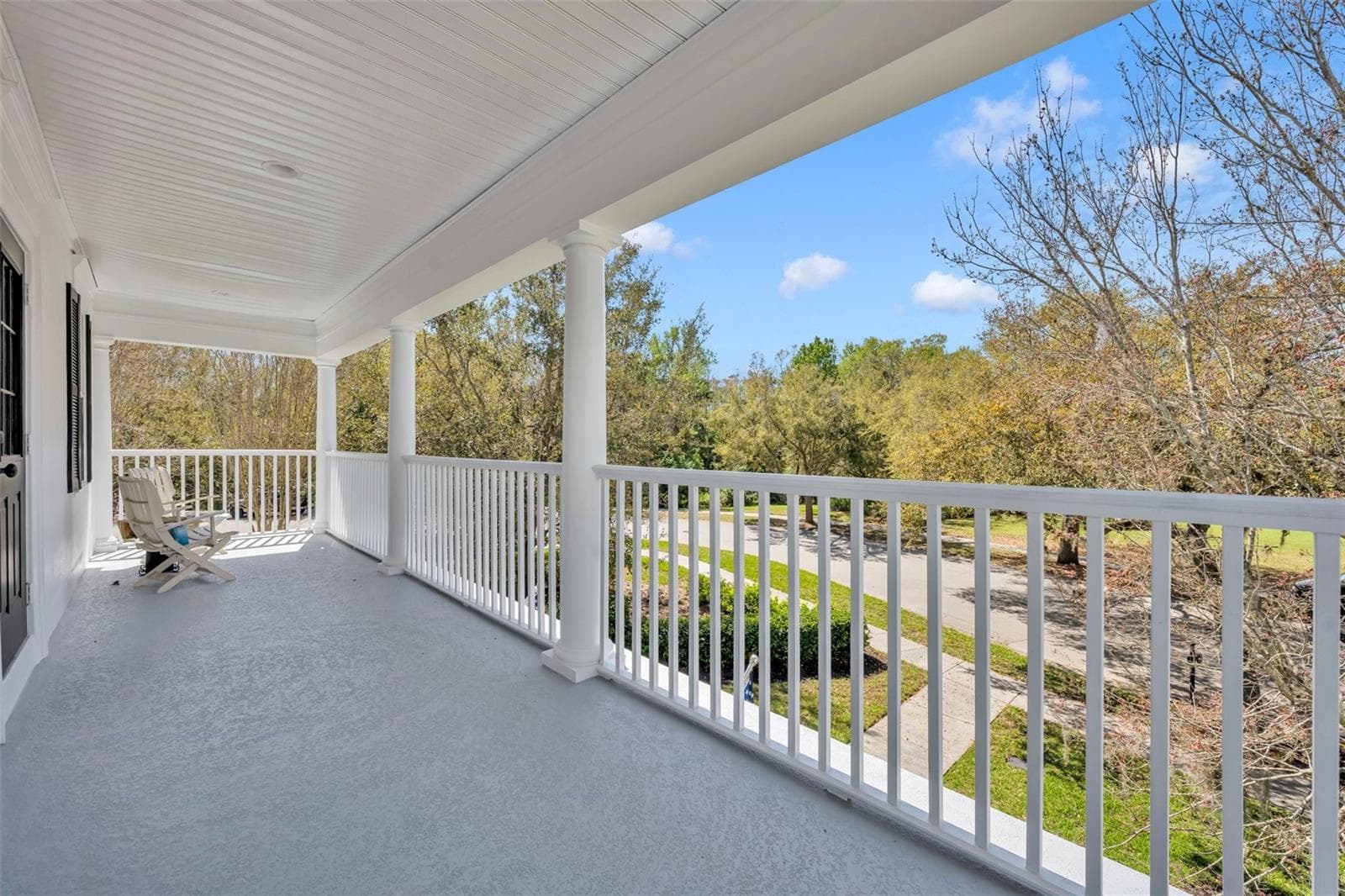 View from second floor primary bedroom balcony. - 807 OAK SHADOWS RD, CELEBRATION