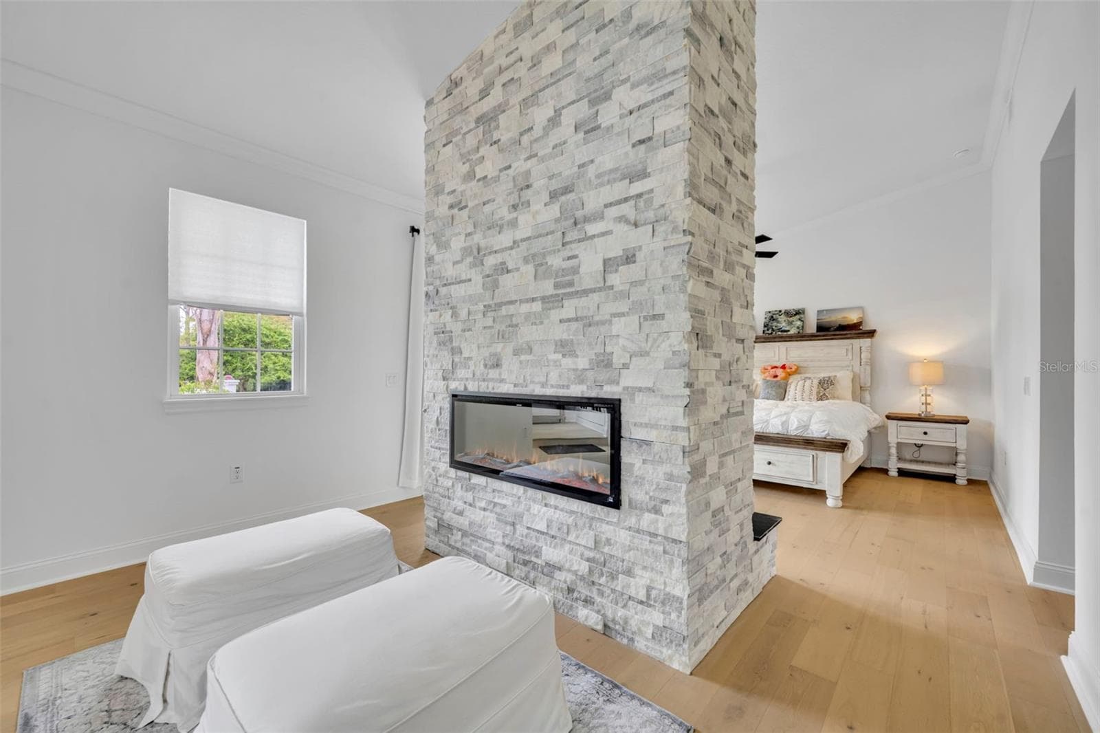 Double sided fireplace in First Floor Primary Bedroom - 807 OAK SHADOWS RD, CELEBRATION