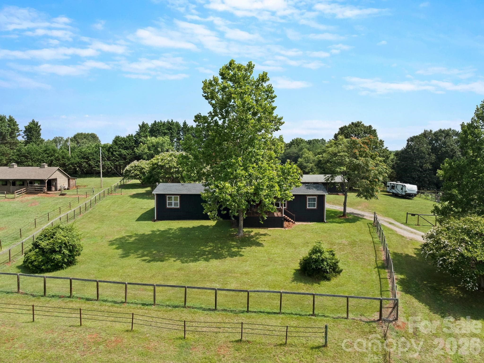 The large area around the house is fenced for dogs with a gate on the driveway. - 1541 Sandy Springs Road, Rutherfordton