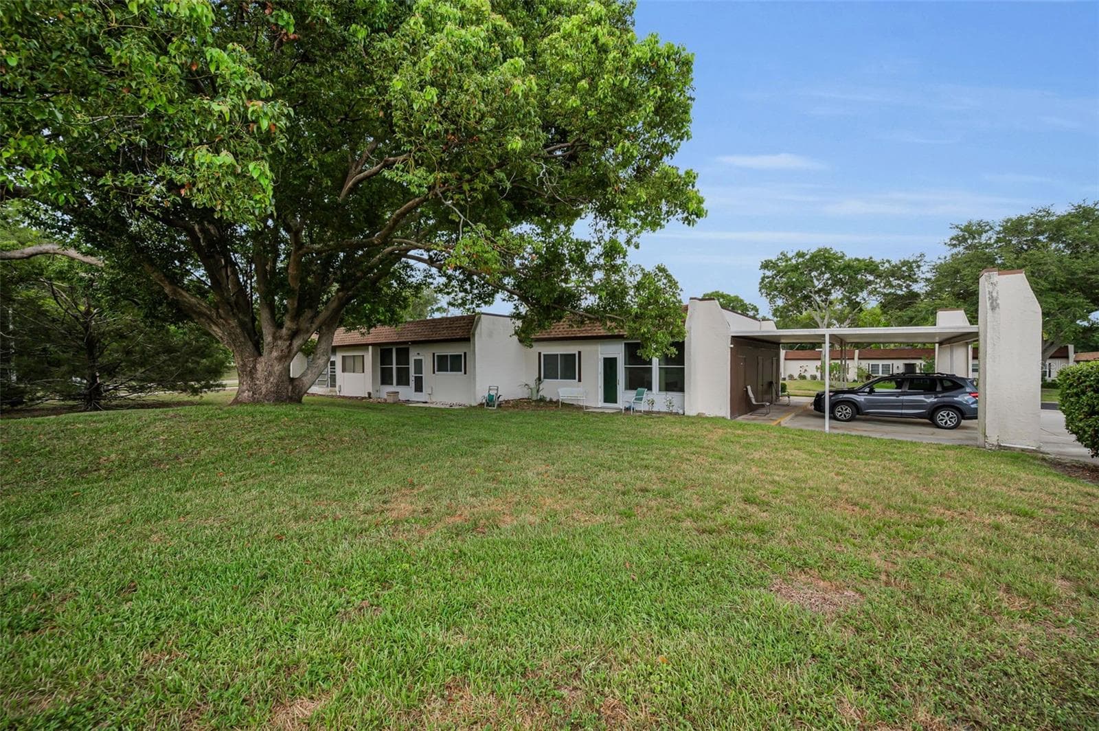 Carport space and view of the lanai - 3097 MISSION GROVE DR, PALM HARBOR