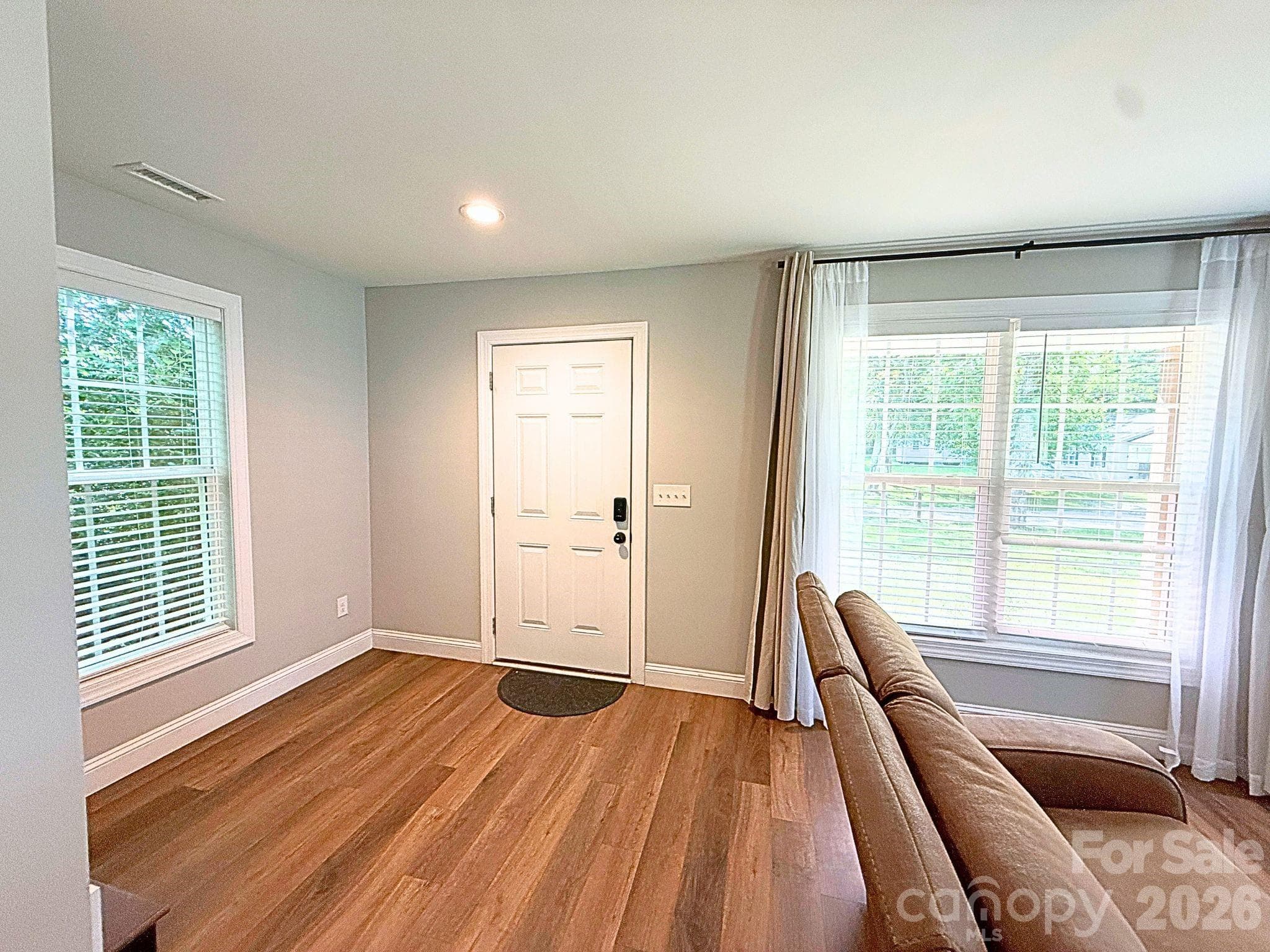 Living Room – Bright living room with luxury vinyl plank flooring, neutral paint, and oversized windows that fill the space with natural light. - Chester