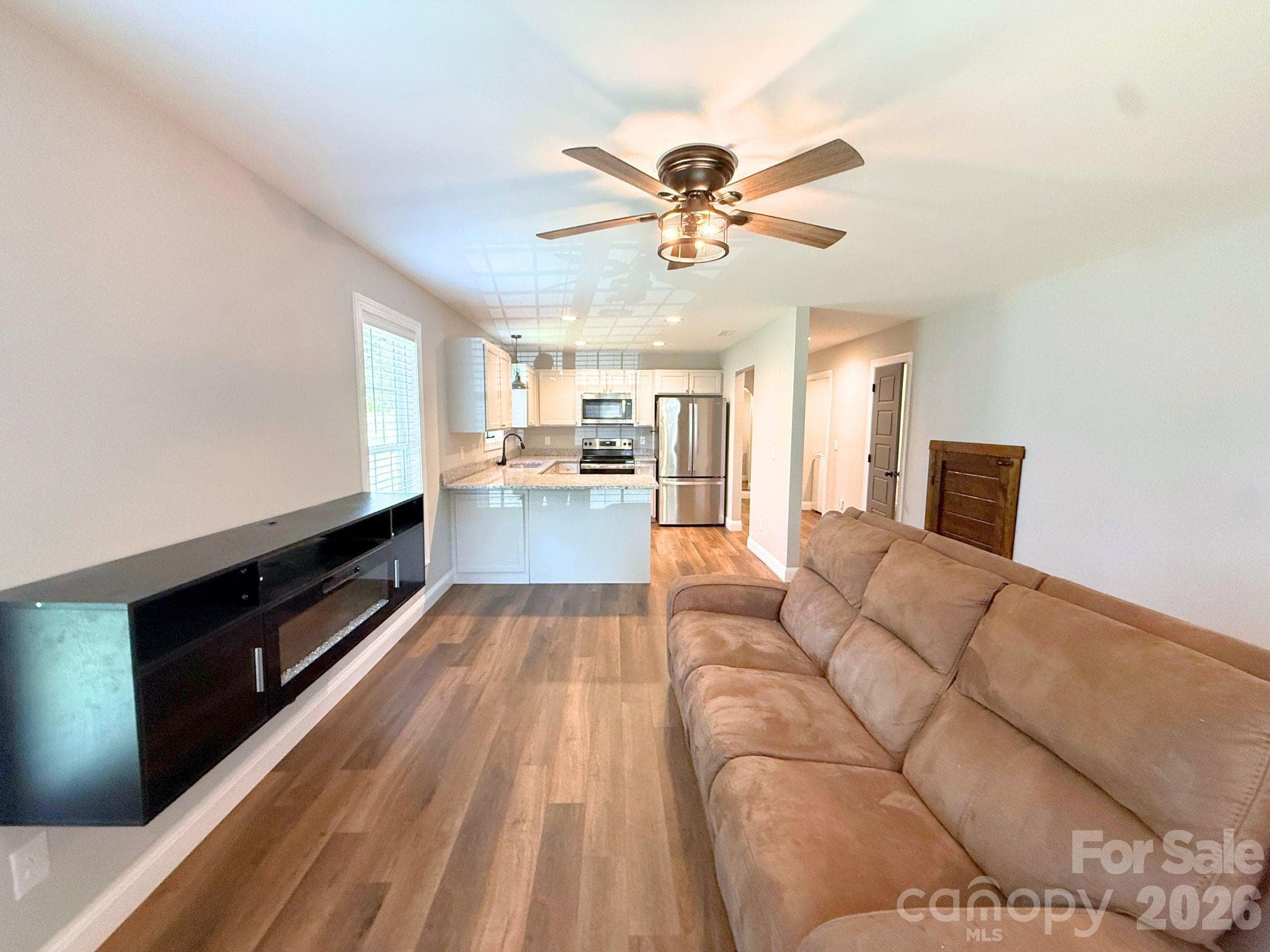 Living Room – Comfortable open living space featuring modern flooring, abundant natural light, and easy flow into the kitchen. - Chester