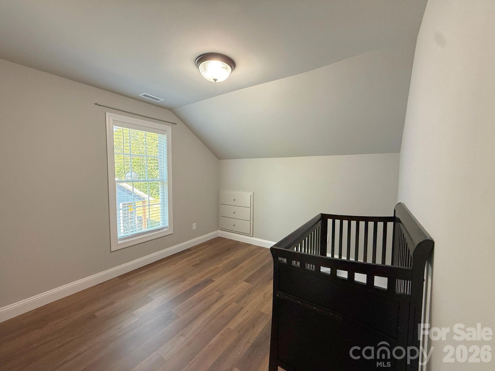 Upstairs Bedroom – Bright secondary bedroom featuring abundant natural light, sloped ceilings, and built-in storage tucked neatly into the wall. - Chester