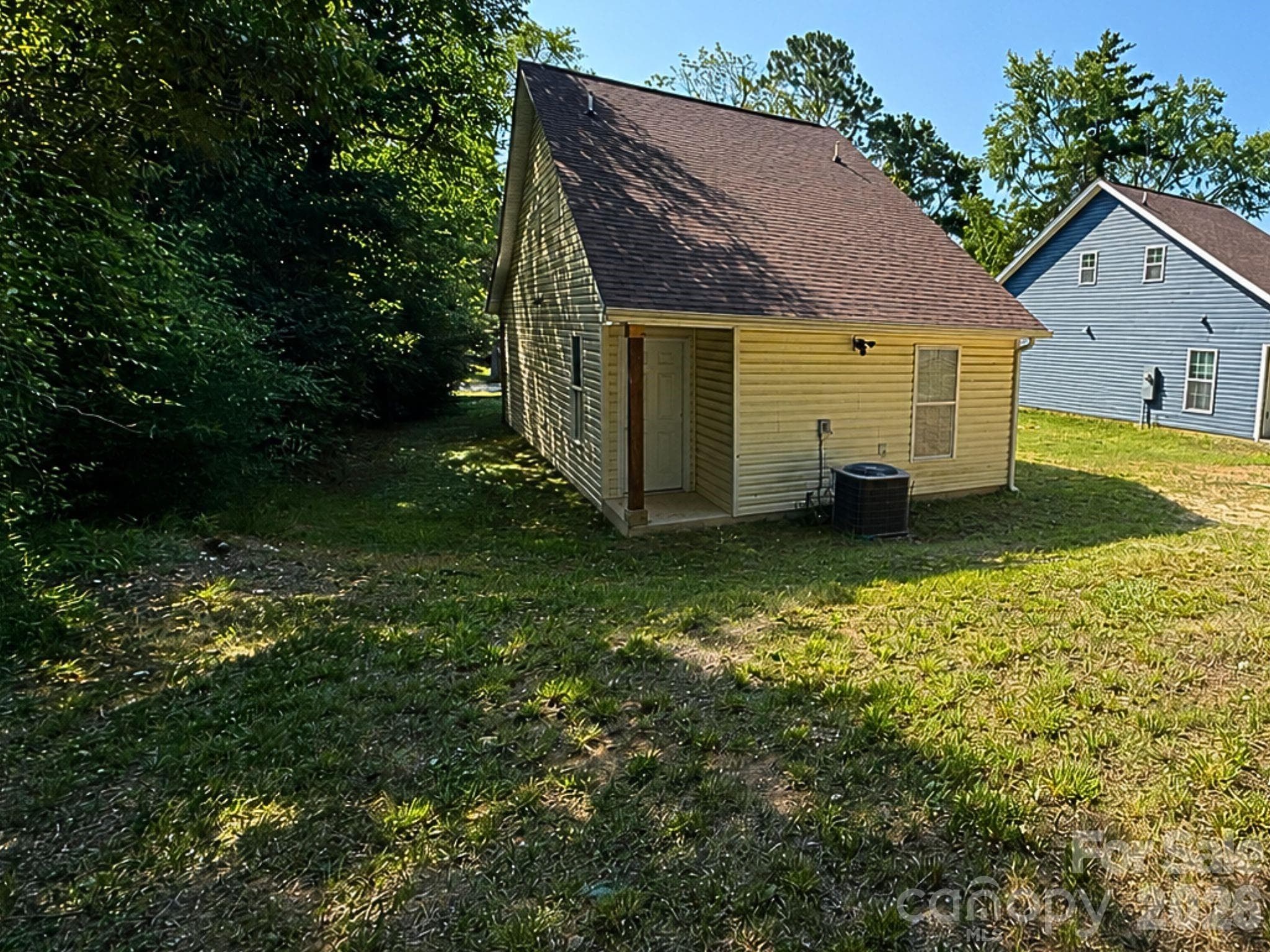 Rear Exterior – Rear exterior offers low-maintenance siding, a secondary covered entry, and a spacious backyard with room to enjoy outdoor living. - Chester
